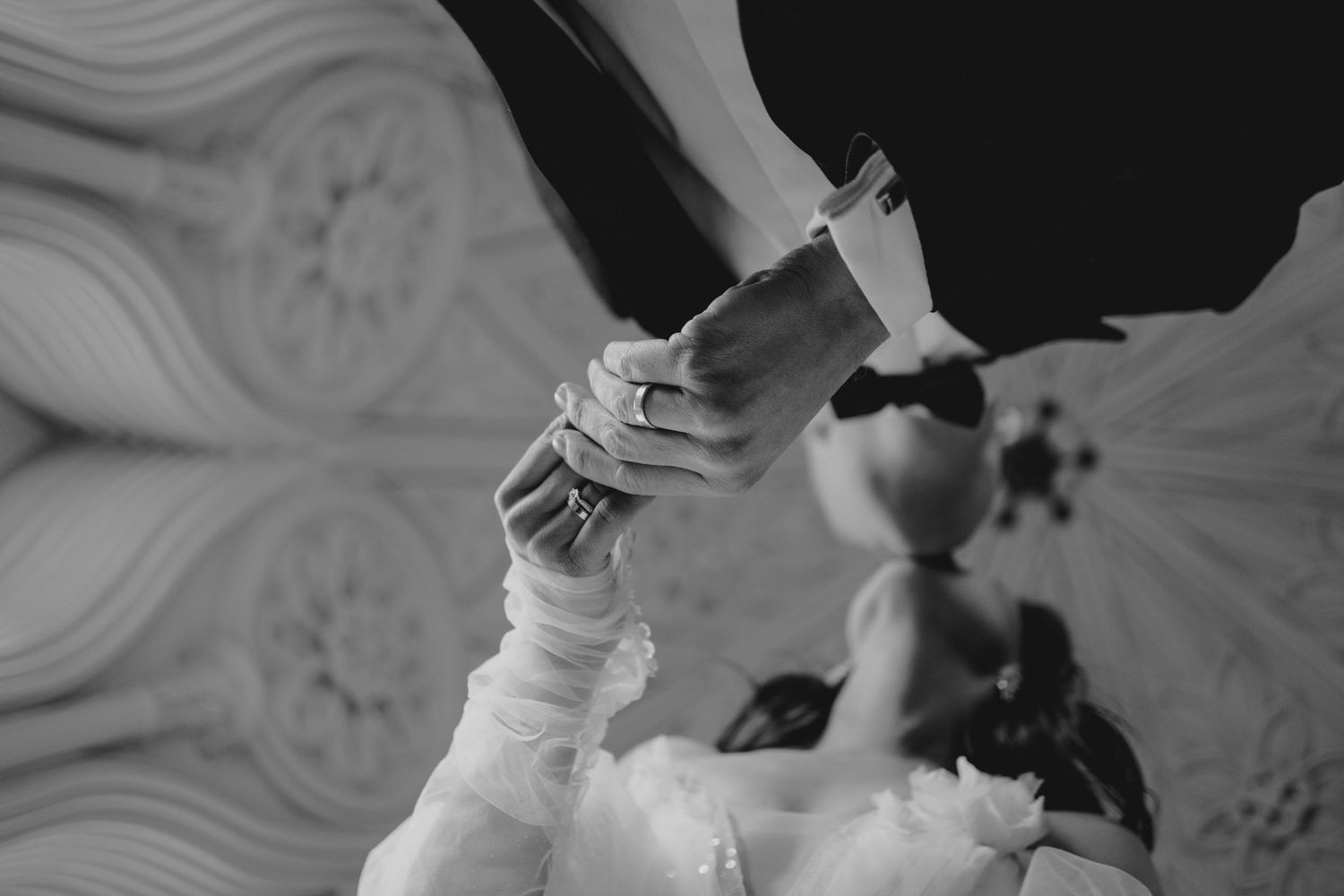 Elegant dance movements captured in black and white against architectural details.