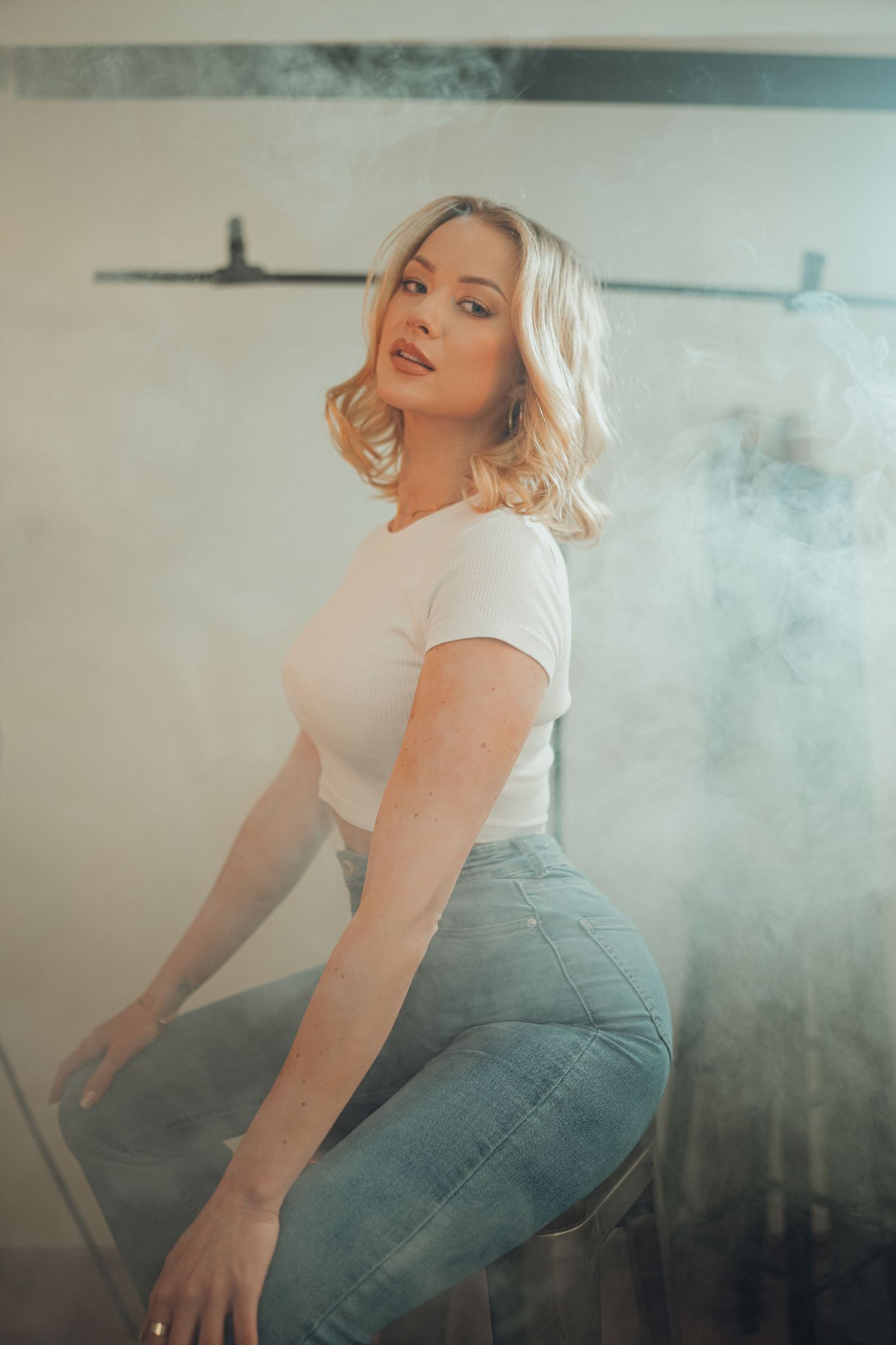 Stylish portrait with smoky atmosphere and moody lighting.