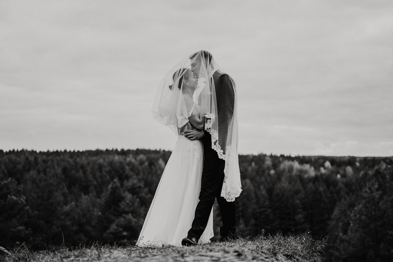 Black and white wedding photos taken in scenic outdoor setting.
