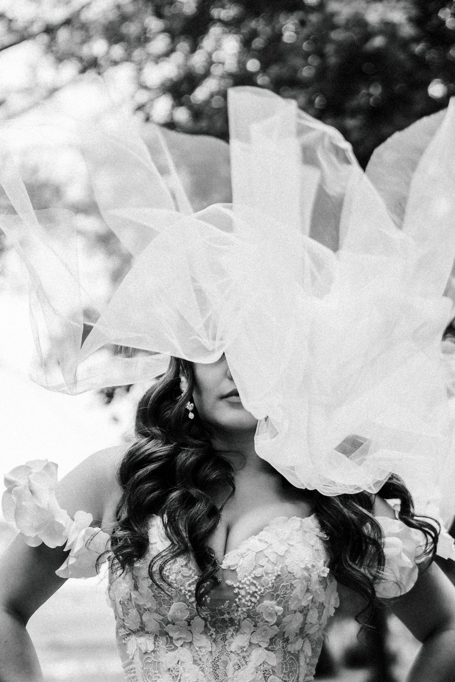 Ethereal black and white portrait featuring flowing white fabric and lace details.