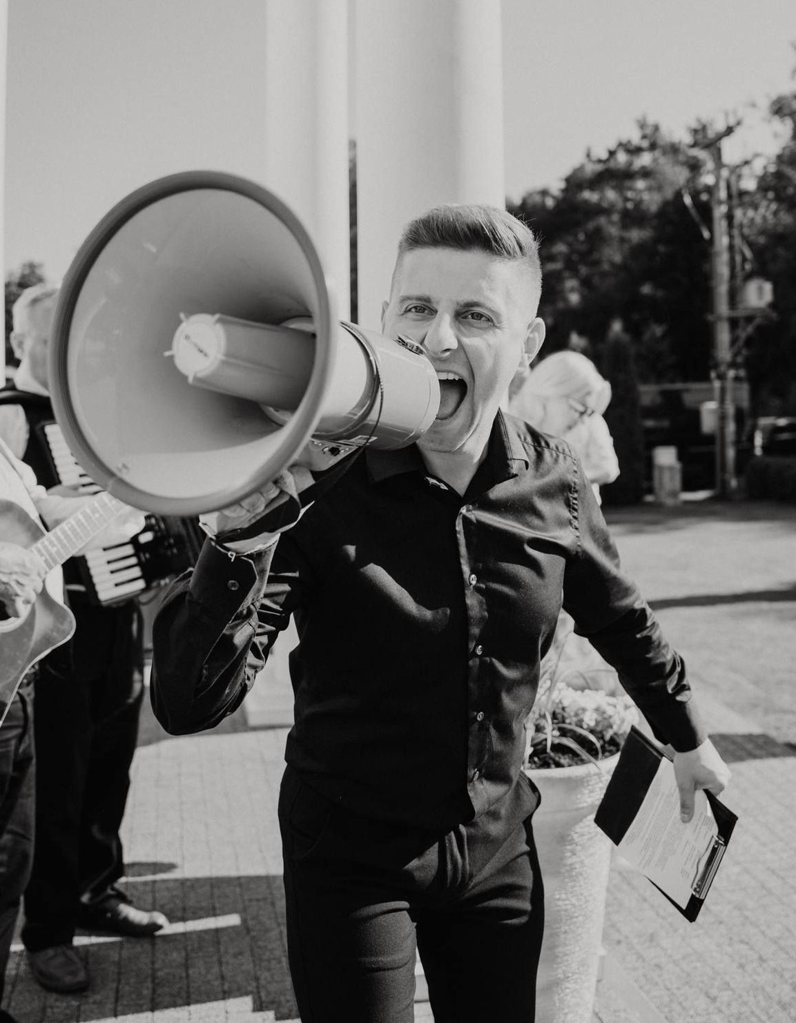A sequence of black and white photos showing someone speaking through a megaphone or bullhorn outdoors.