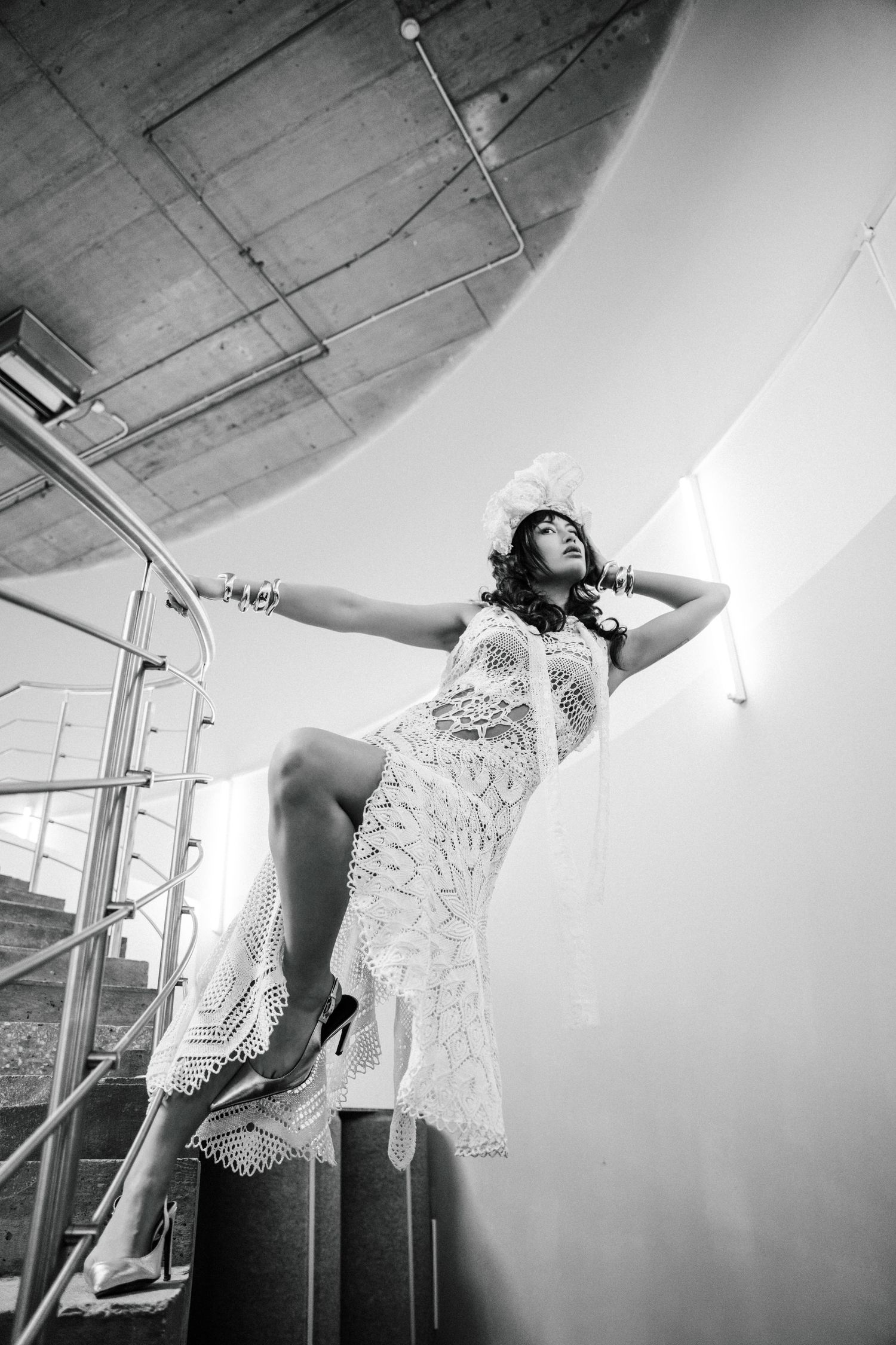 A graceful dancer in white lace performs an expressive contemporary dance sequence in a studio setting.