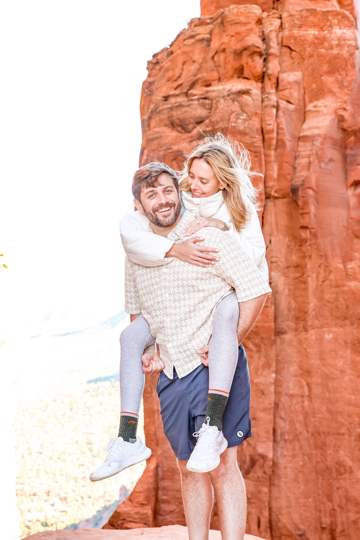 Joyful interaction between couple against towering red rock formations in Sedona Arizona.