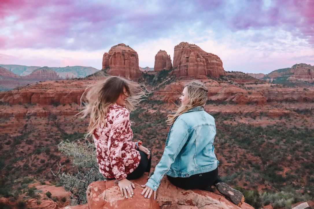 Scenic desert landscape with towering red rock formations and mountains in the distance in Sedona Arizona.
