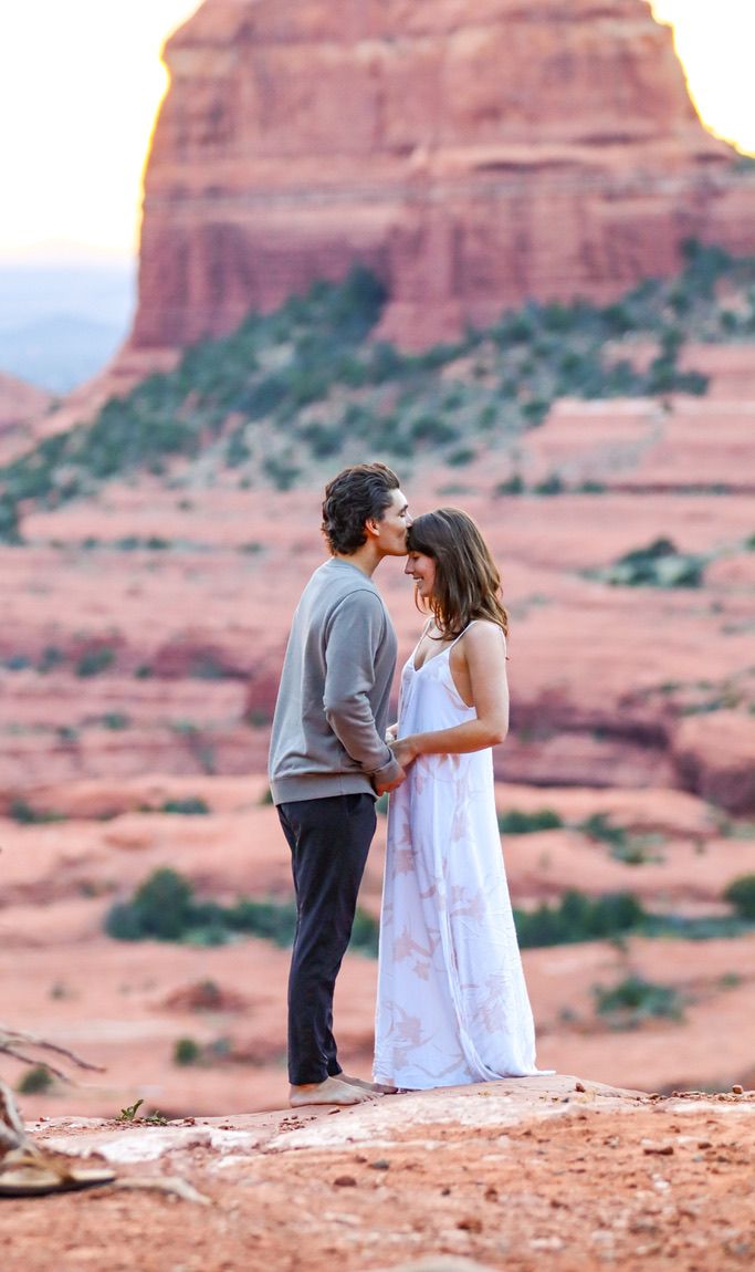 A romantic moment captured against majestic red rock formations in Sedona.