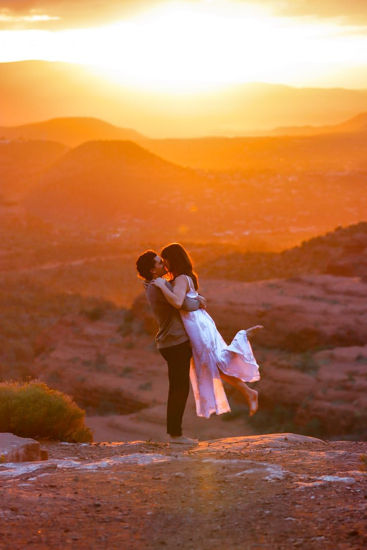 A romantic silhouette against a golden sunset sky in the desert mountains in Sedona Arizona.