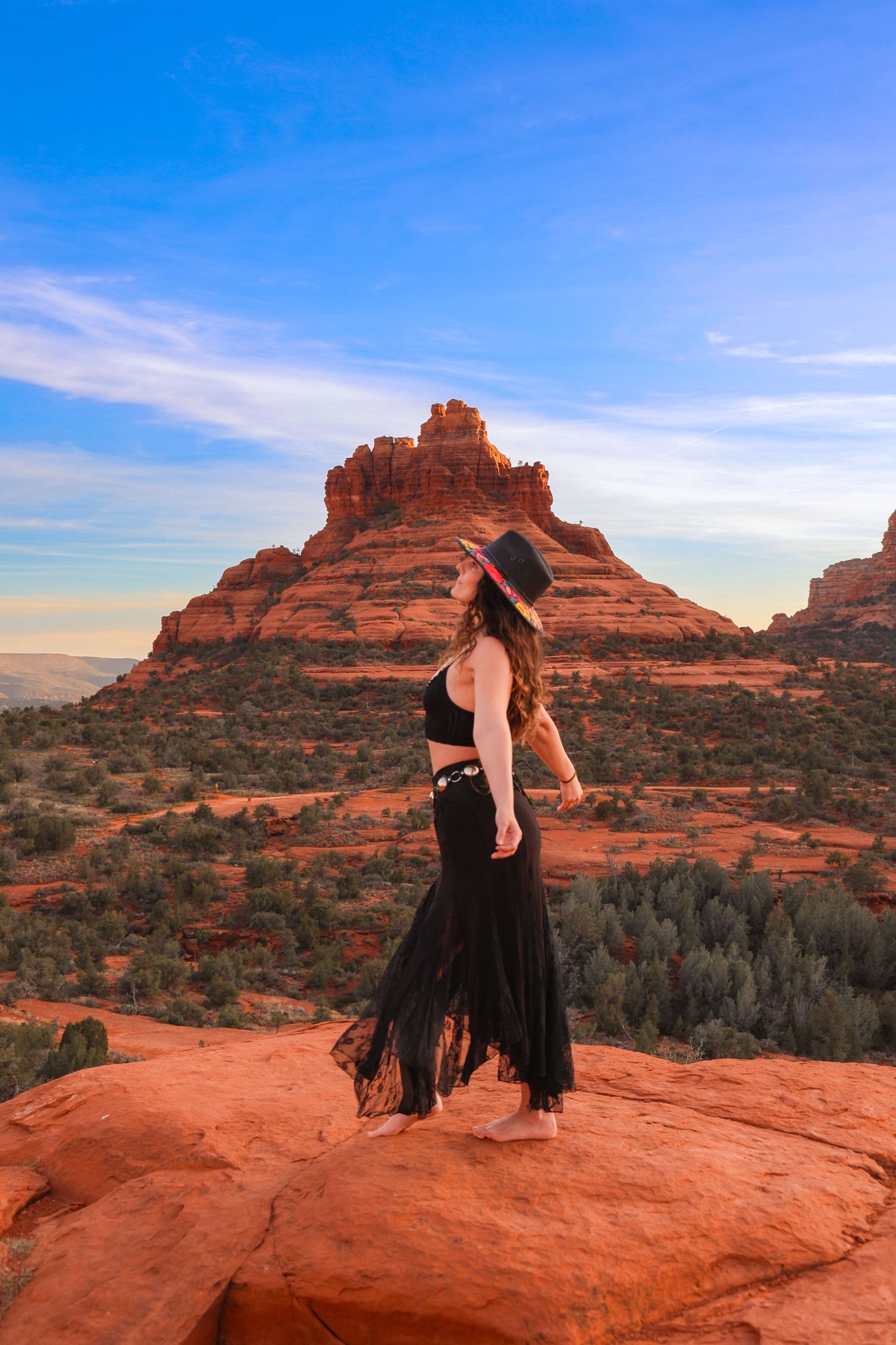 Dramatic red rock formations of Bell Rock in Sedona provide a stunning backdrop against bright blue Arizona skies.