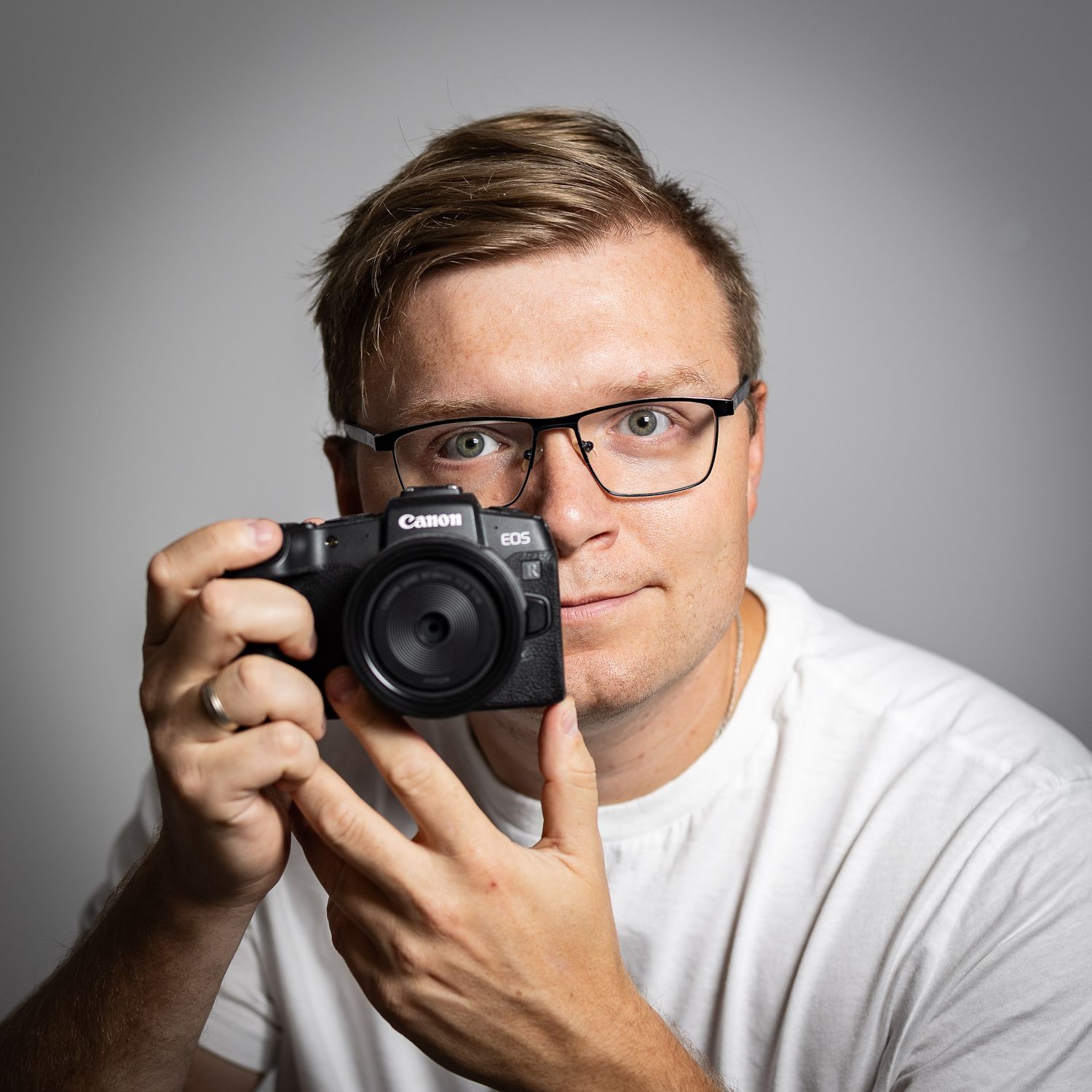A series of portrait shots showing a photographer using a camera against a light background.