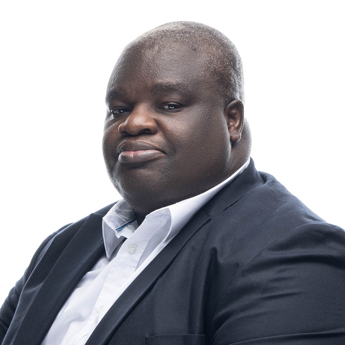 Professional portraits in black suit and white shirt against white backdrop.