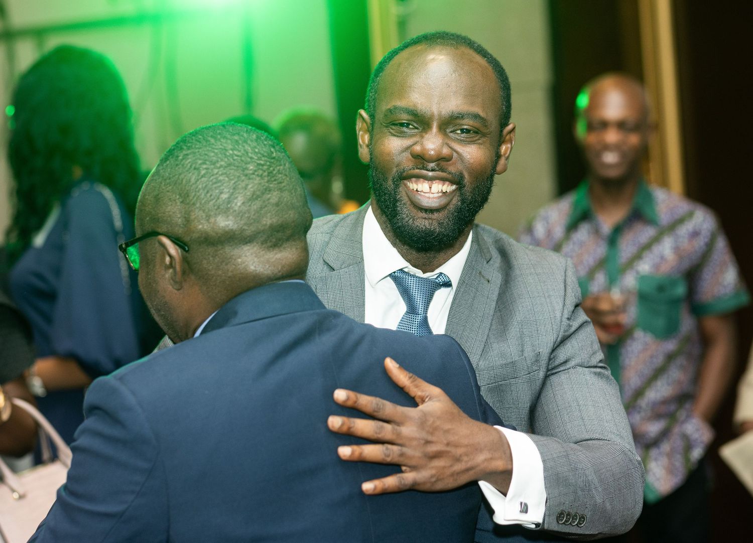 A collage of photos showing someone in a grey suit smiling and gesturing expressively in various poses.