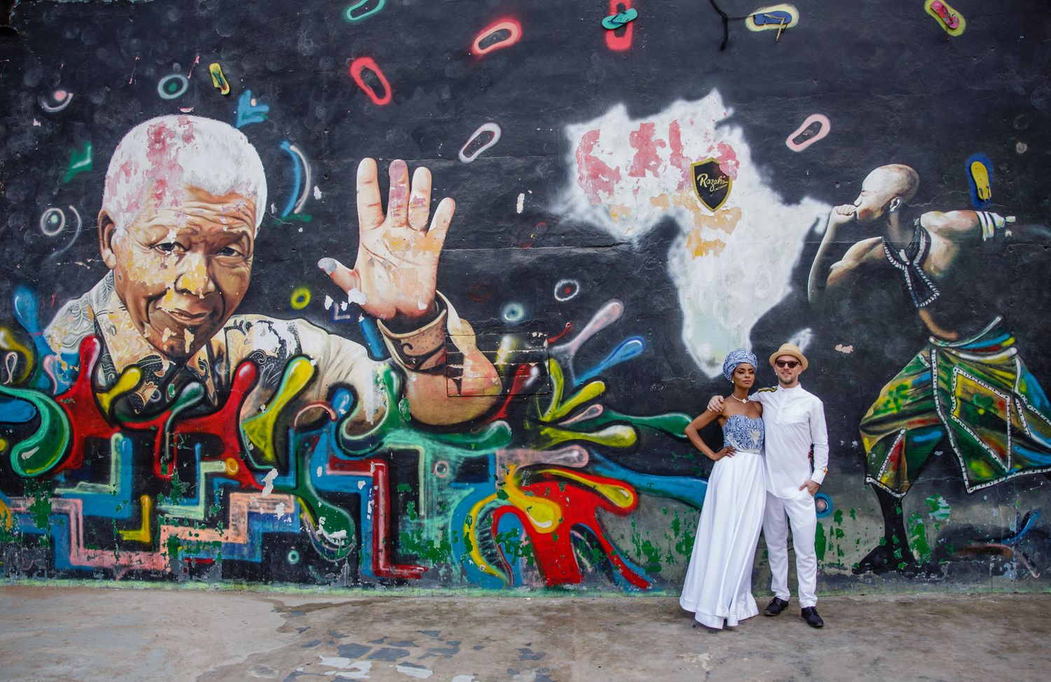 A series of colorful graffiti murals painted on a concrete wall showcase vibrant street art and urban culture.