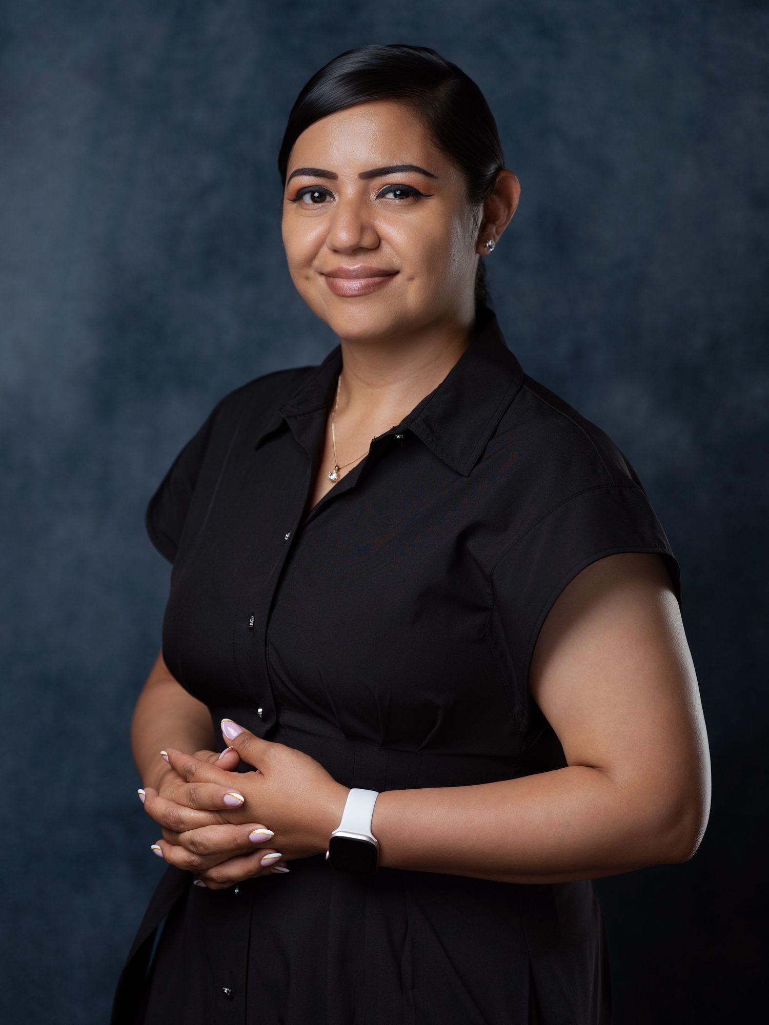 Professional studio portraits in black attire against a dark background.