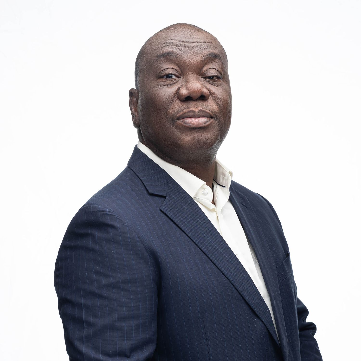 Professional headshots of businessman in navy suit showing various expressions.
