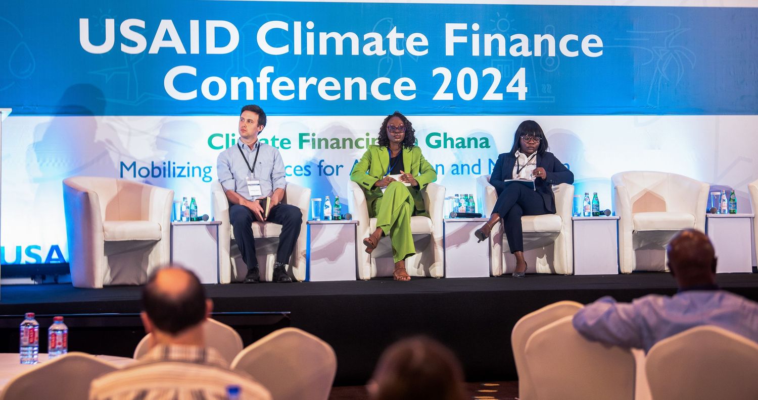 USAID Climate Finance Conference 2024 banner displayed at professional event.