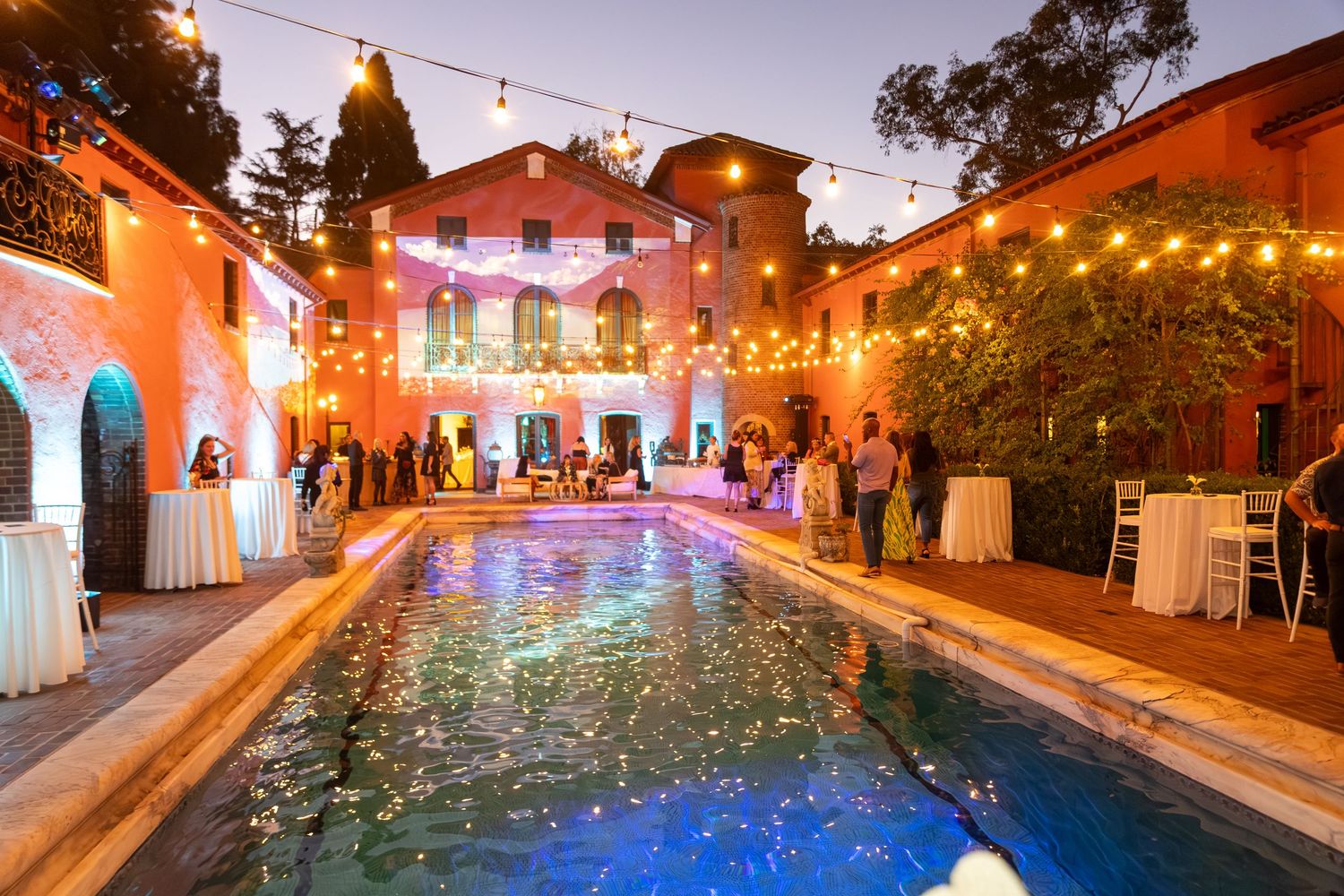 Outdoor venue with string lights and colorful illumination creating a festive atmosphere.