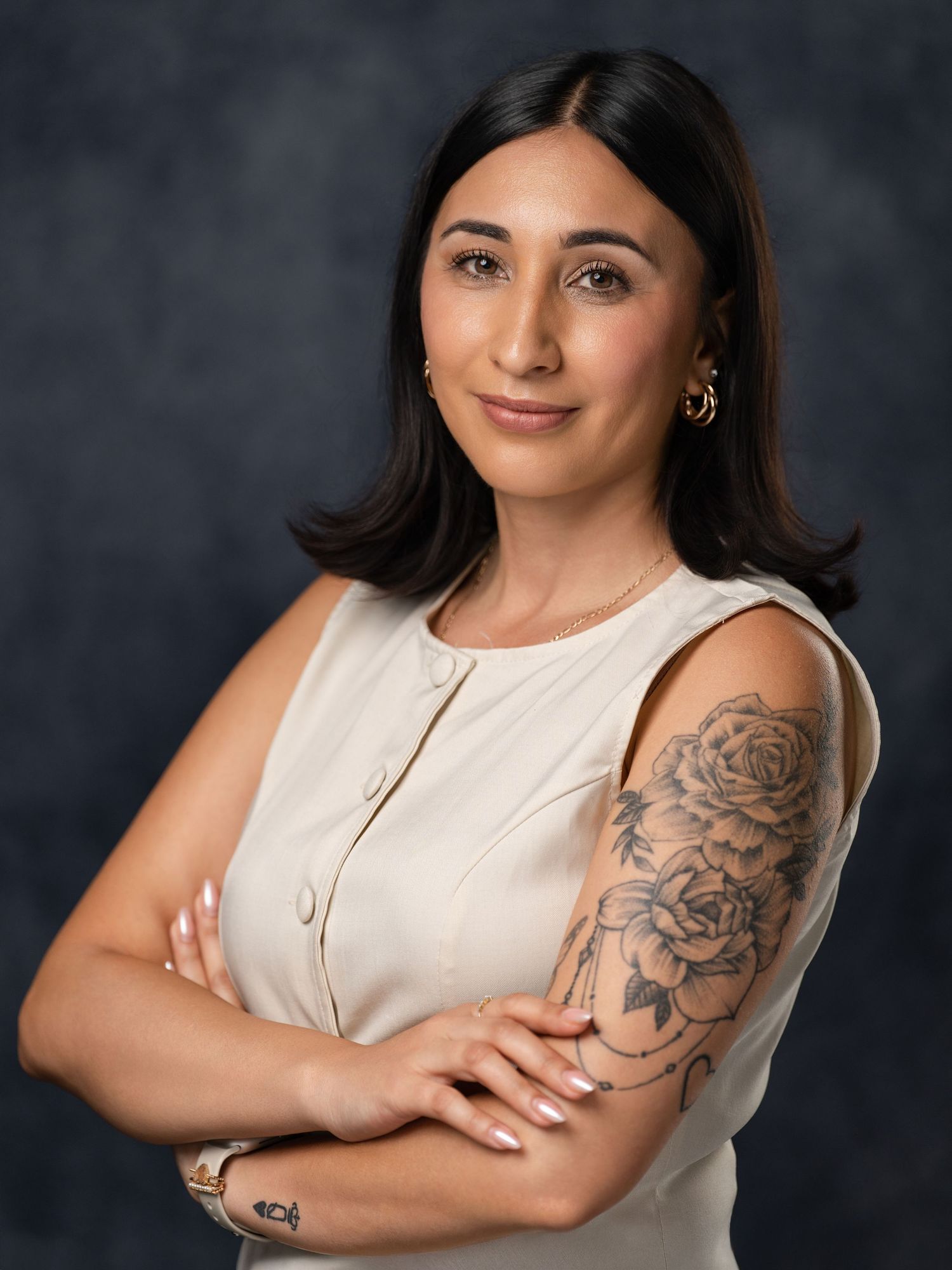 Studio portrait series showing woman in sleeveless white top with visible arm tattoo.