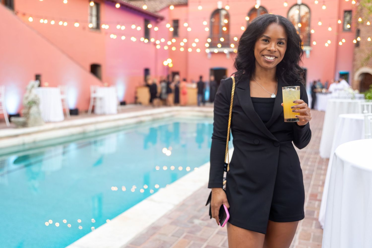 Poolside party venue decorated with string lights and festive atmosphere.