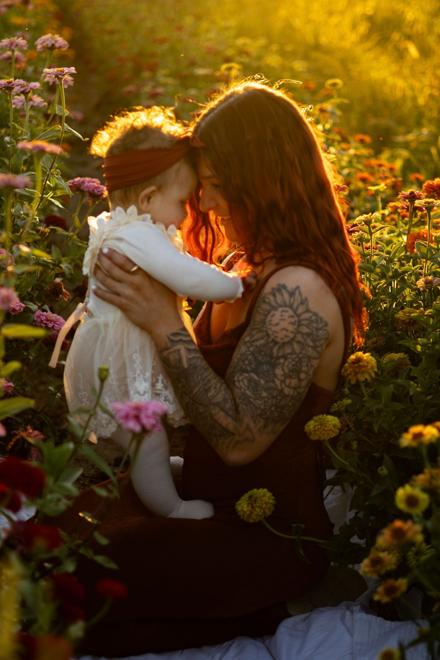 Sunset portrait in a flower garden with warm golden lighting.