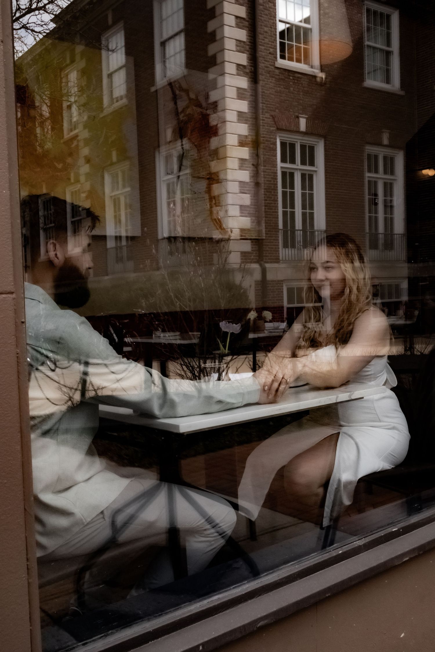 Multiple exposure photo showing movement through window reflections in an urban setting.