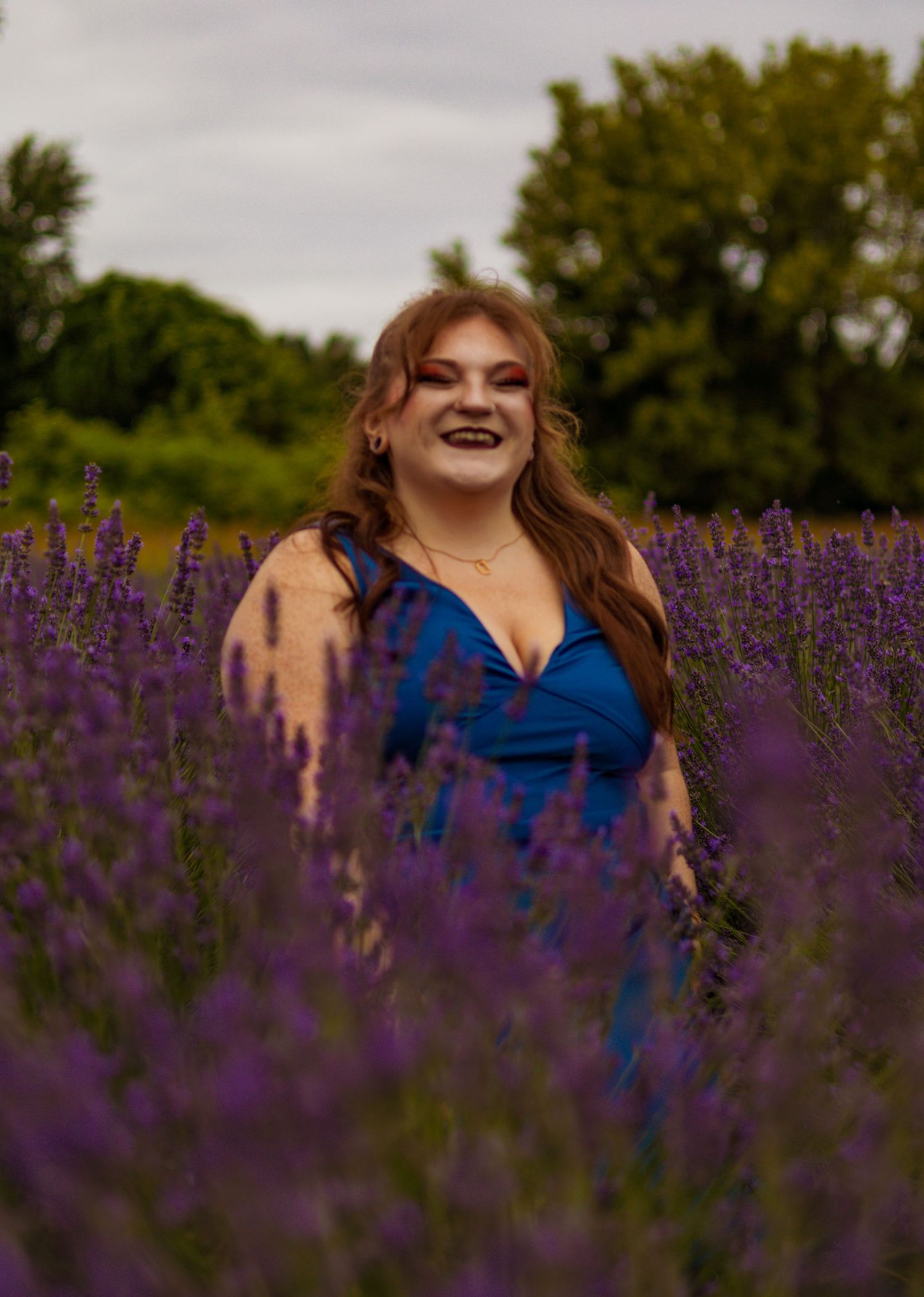 Beautiful portrait series in a blooming purple lavender field under cloudy skies.