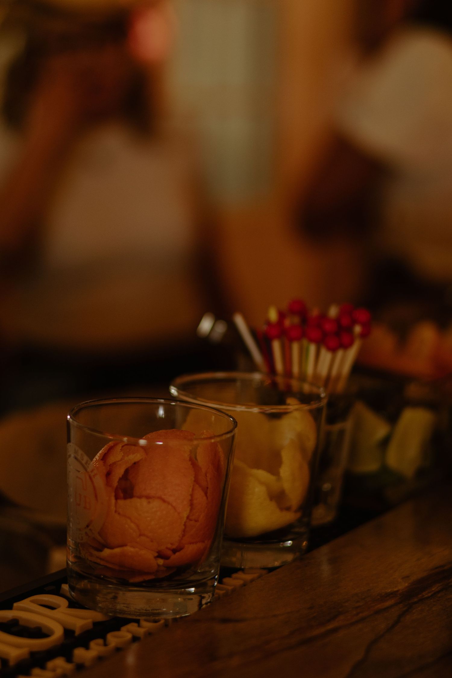 Soft candlelight illuminates a row of small glass votive holders creating a warm, romantic ambiance.