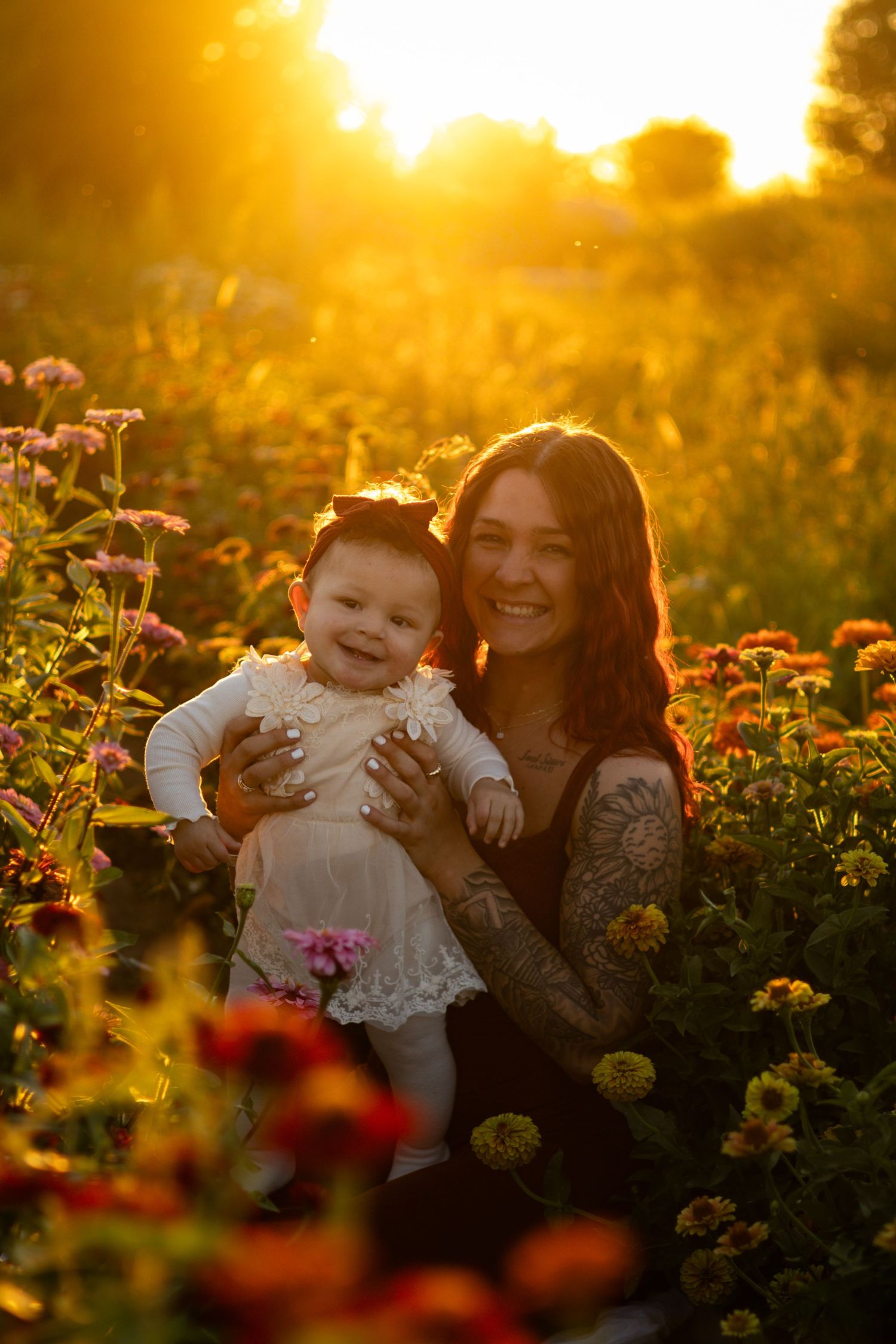 A tender moment captured in a flower field during golden sunset.