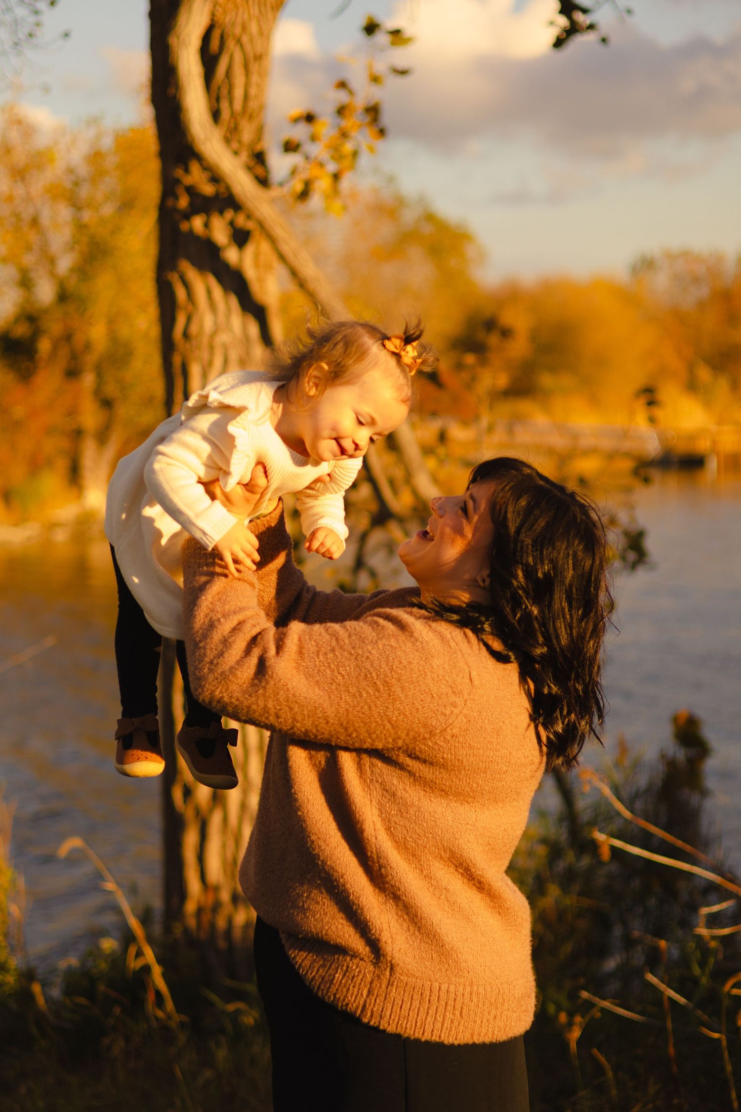 Warm sunset light illuminates playful interactions in an outdoor setting.