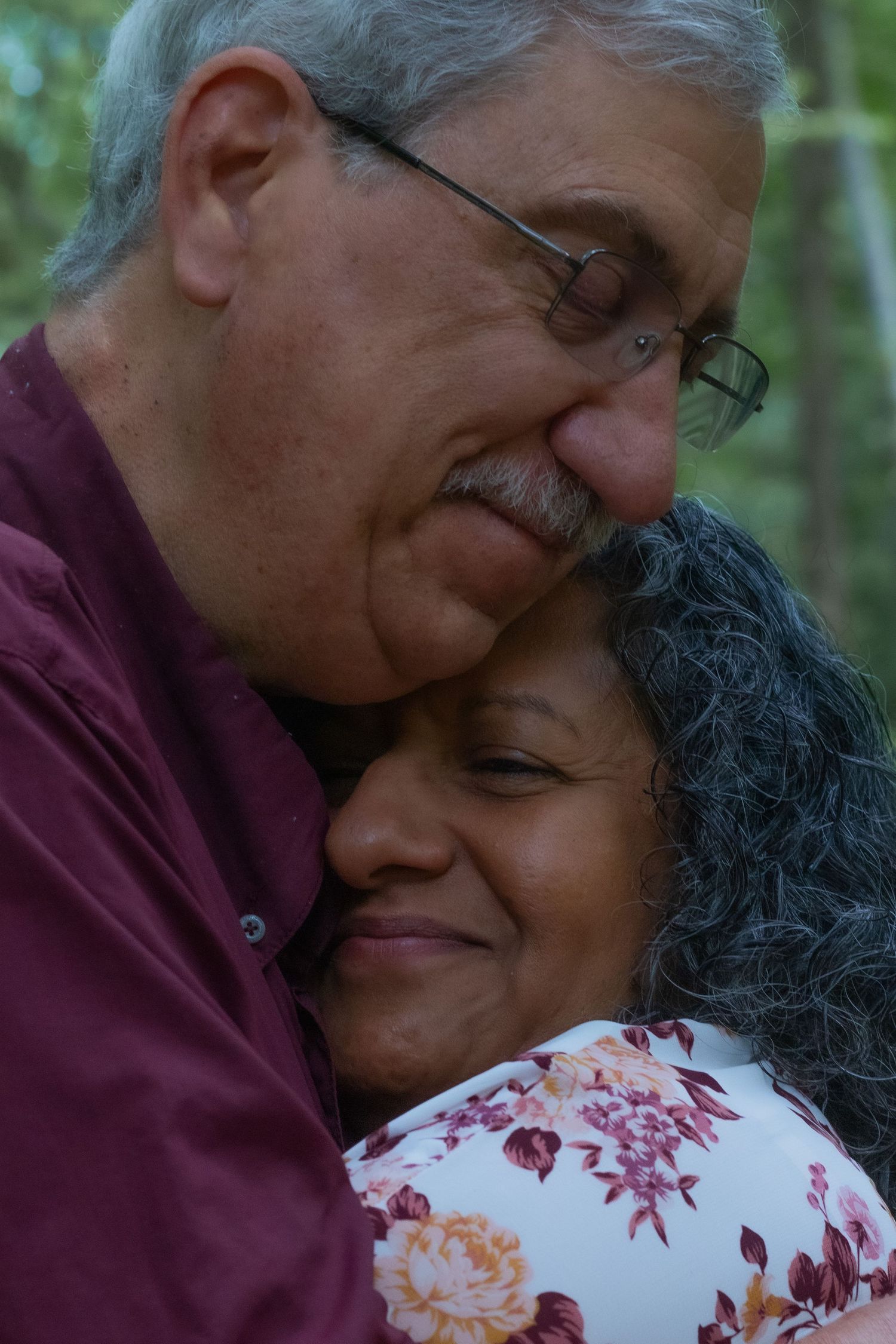 An intimate embrace captured in a natural outdoor setting.