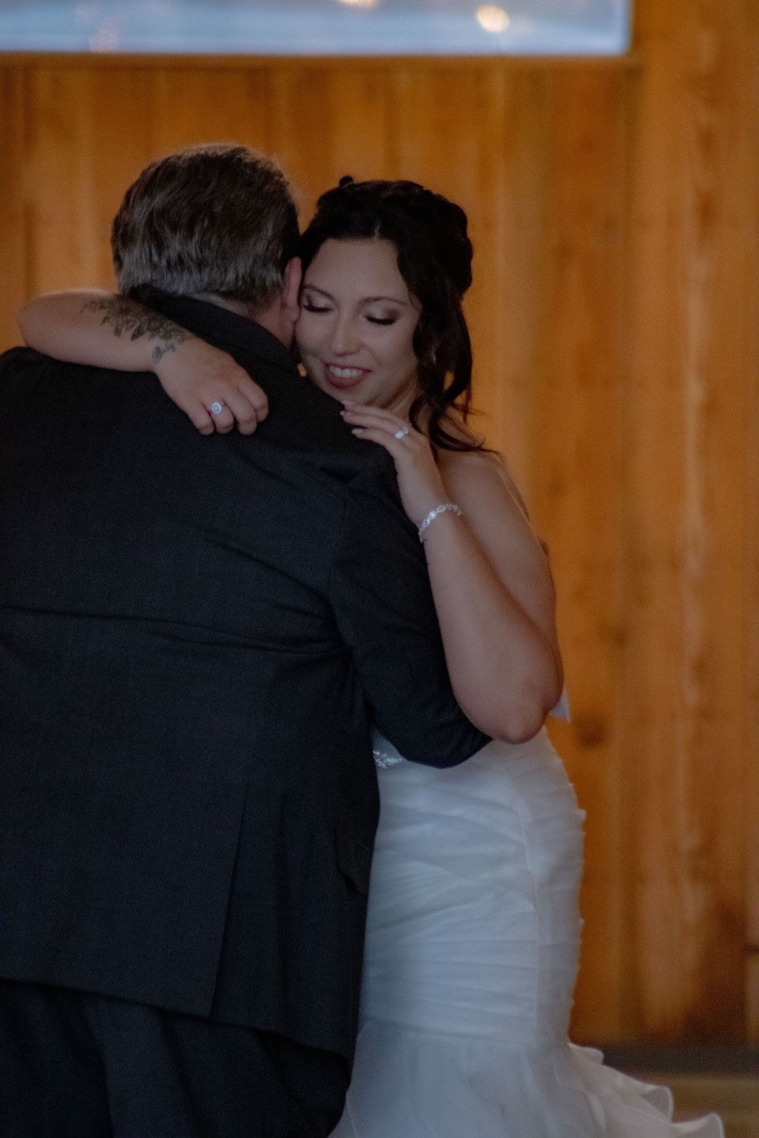 Romantic dance moves shown in a wedding reception venue with warm wood paneling.