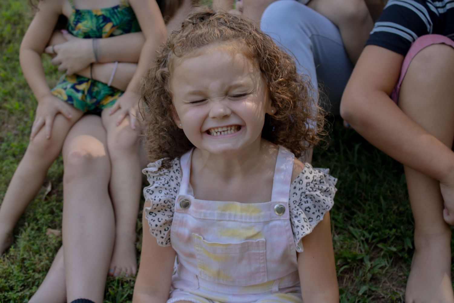 Closeup of joyful expressions during an outdoor group photo session.