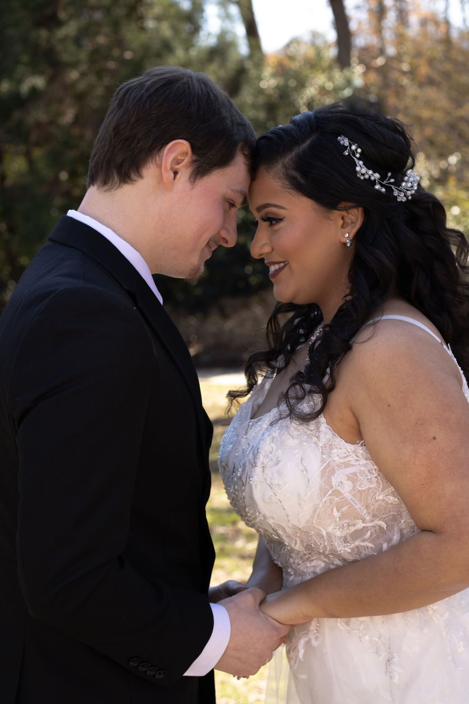An intimate moment between newlyweds as they share a romantic pose outdoors.