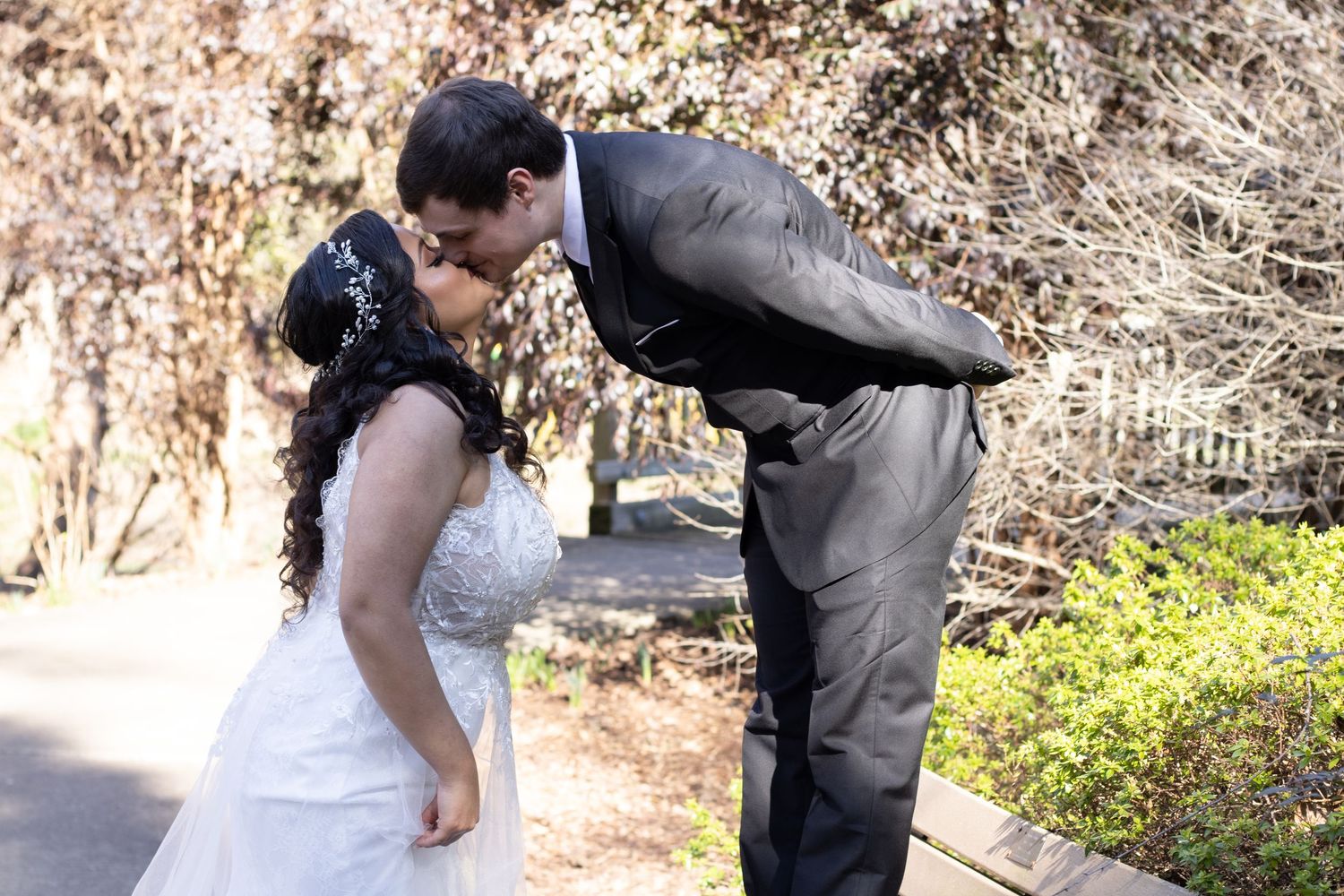 A romantic dip pose captured during an outdoor wedding photoshoot.