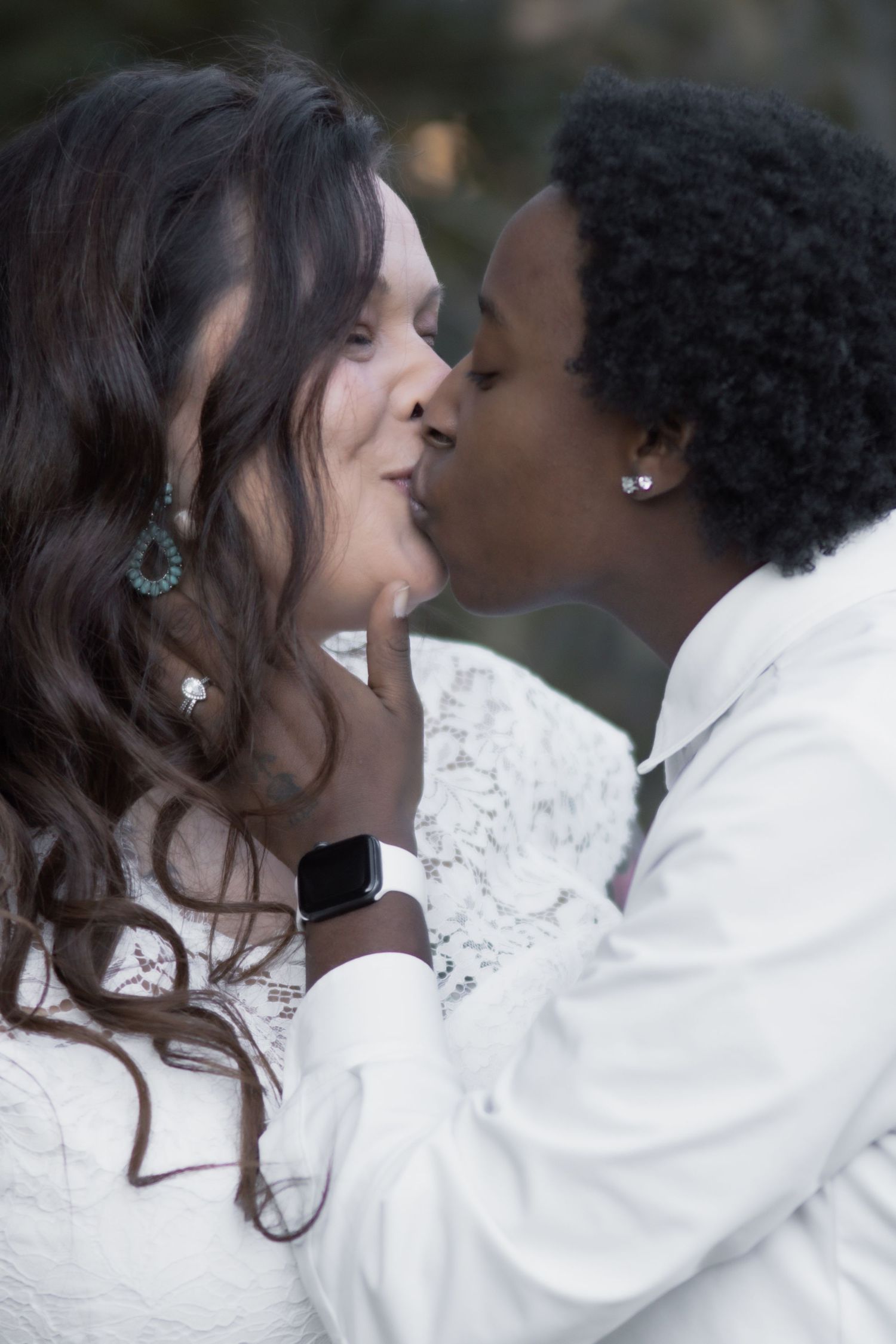 Intimate winter portrait of couple in matching white outfits.