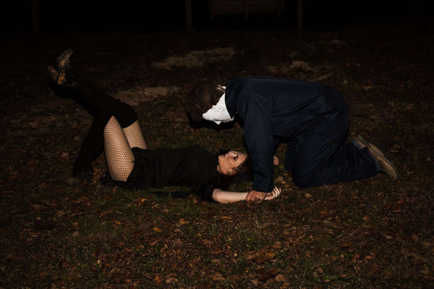 Dramatic nighttime outdoor portrait on dark grass.