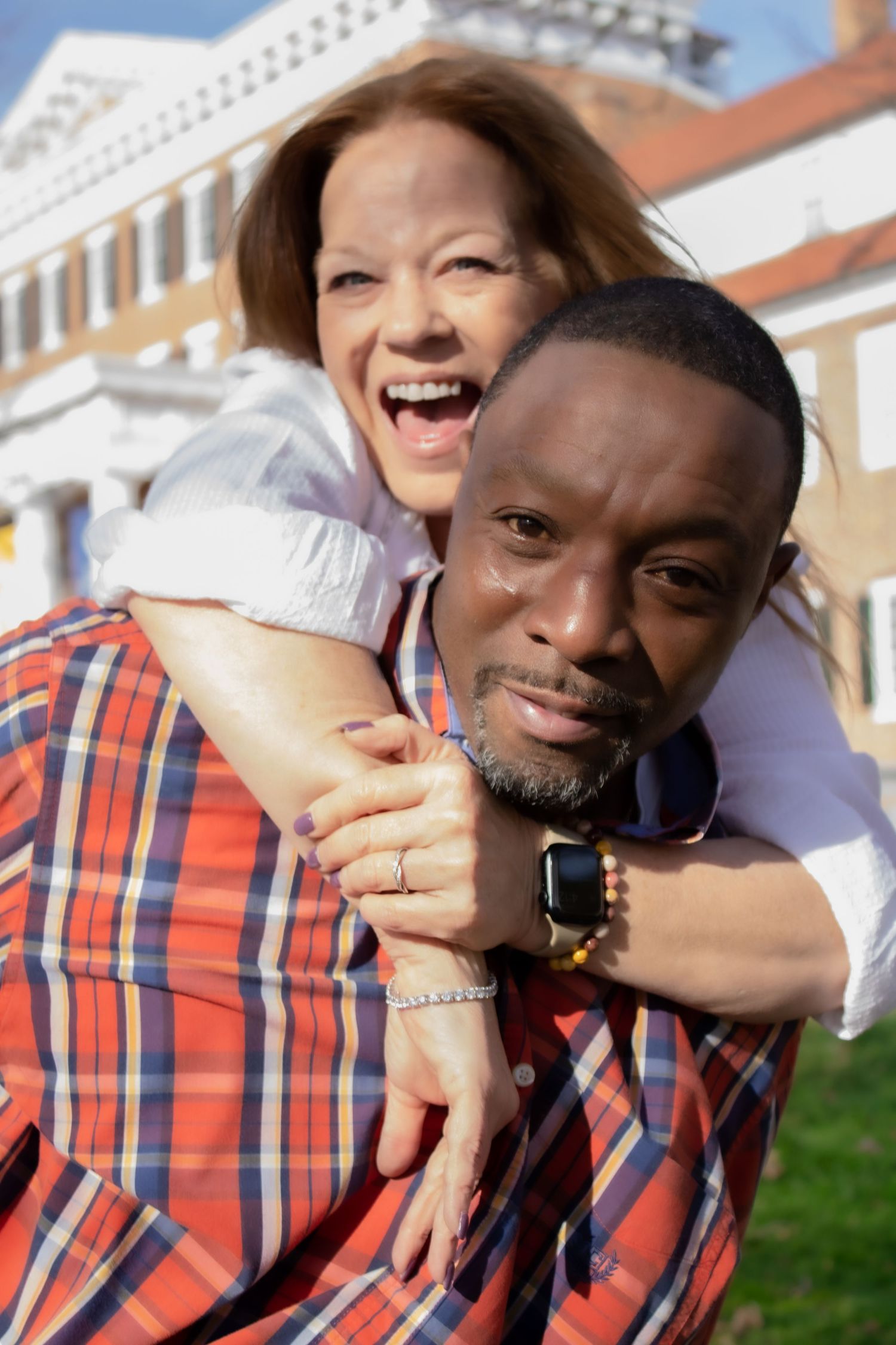 A joyful moment captured between two people outdoors on a sunny day.