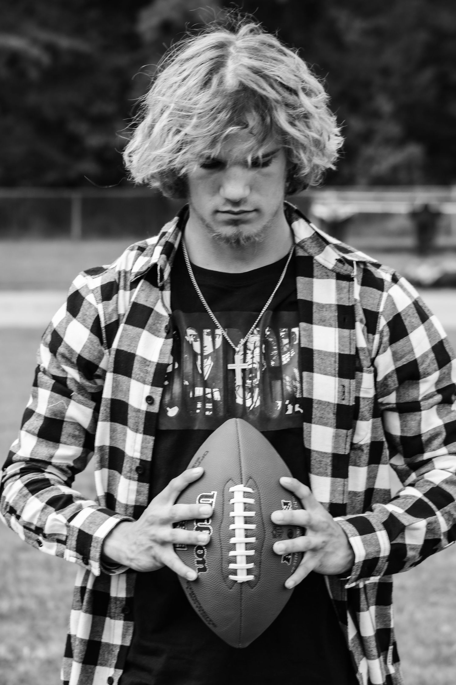 A series of black and white photos showing a football held against a buffalo plaid shirt pattern.