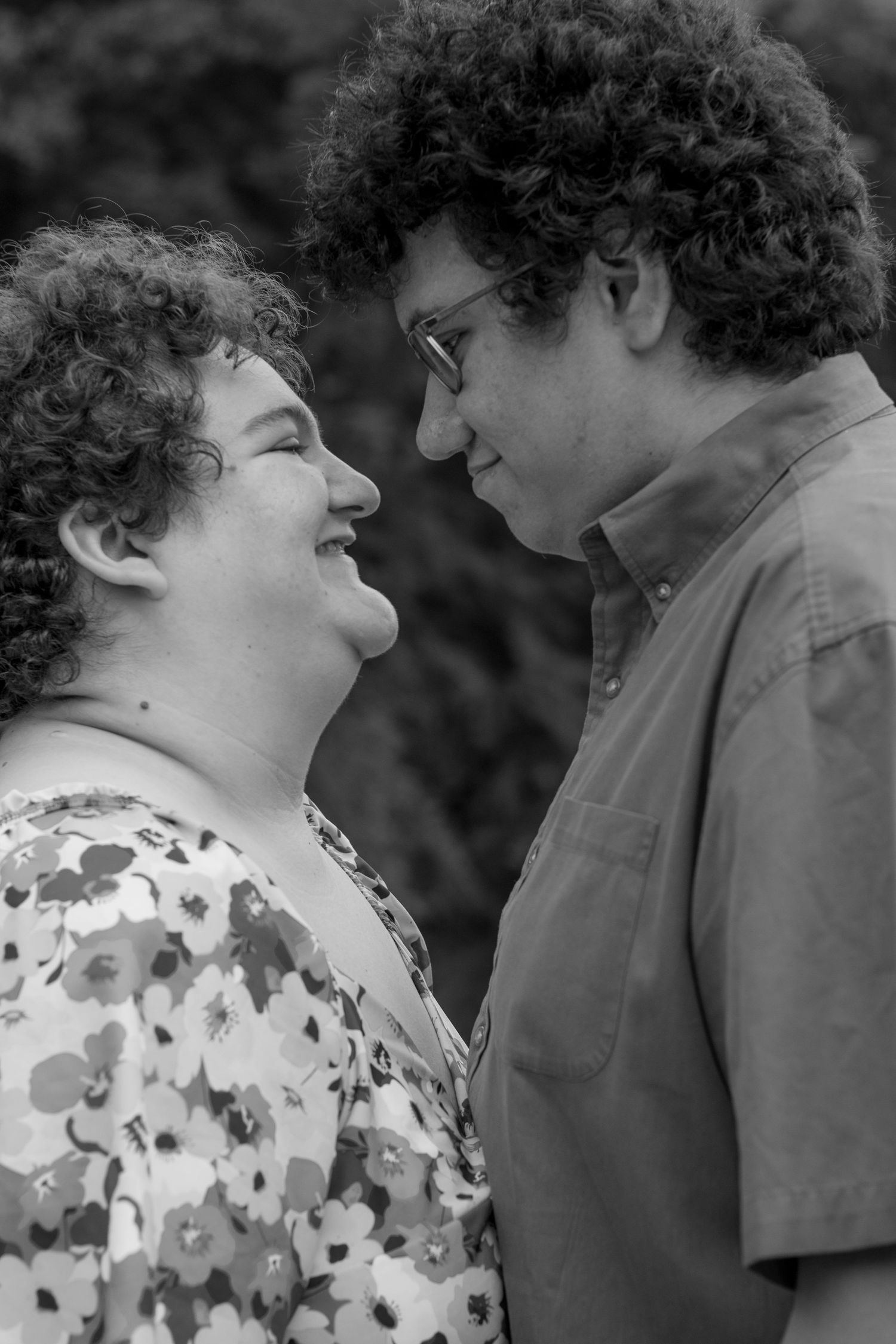 A black and white photo captures a tender interaction between two people.