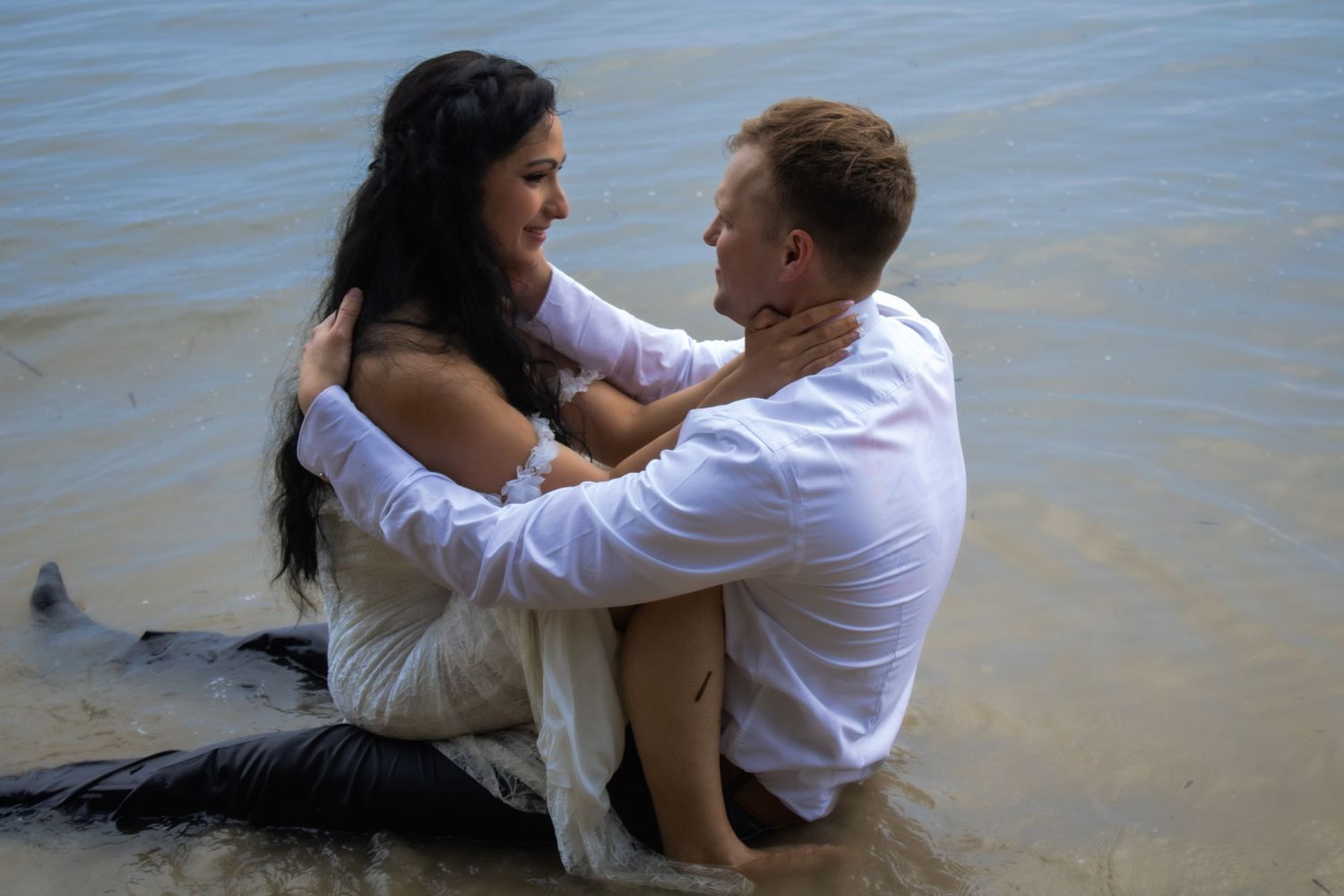 Romantic couple share tender moments at the beach in artistic black and white sequence of photos.