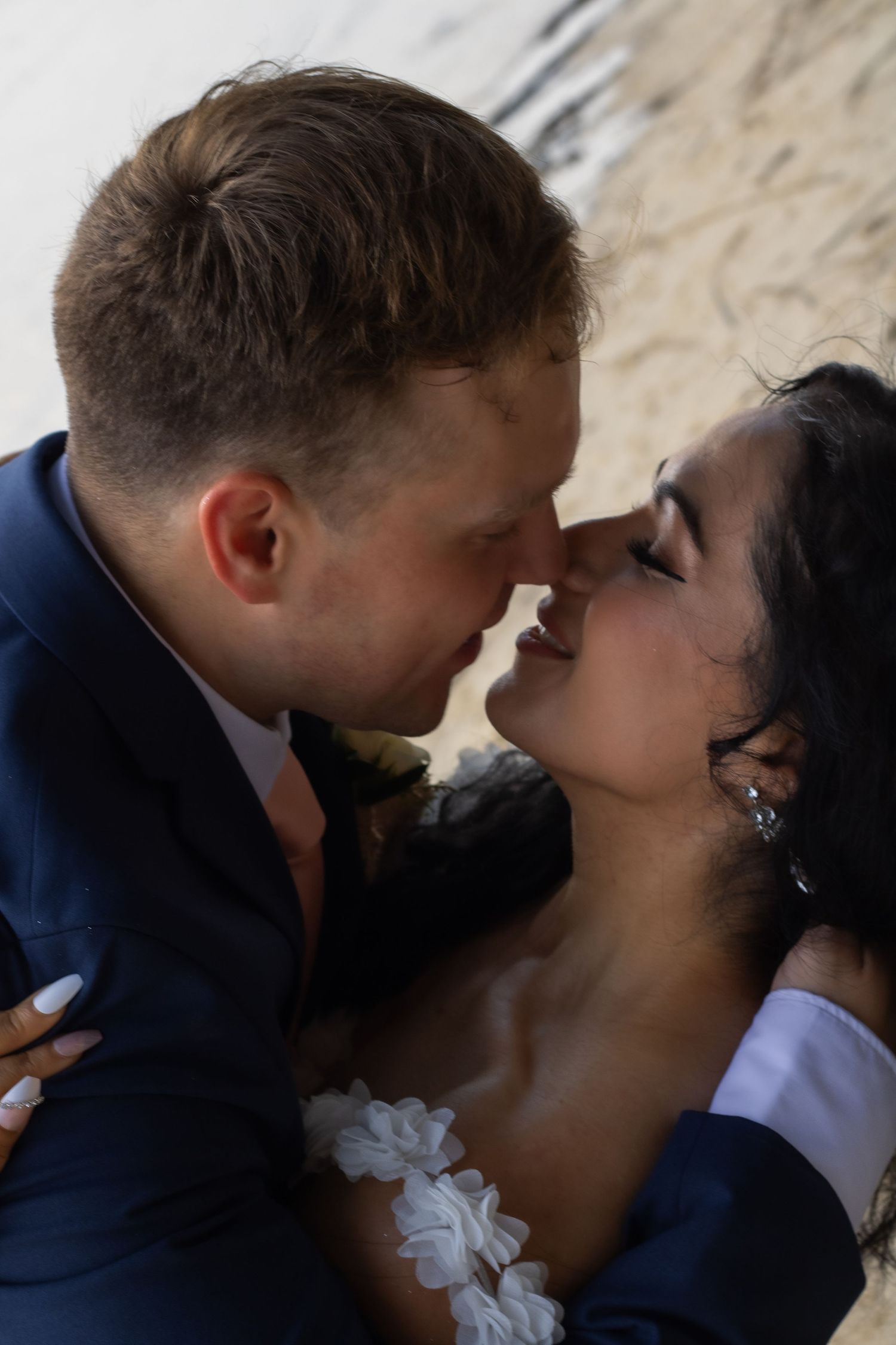 Intimate close-up of a romantic wedding couple sharing a tender moment.