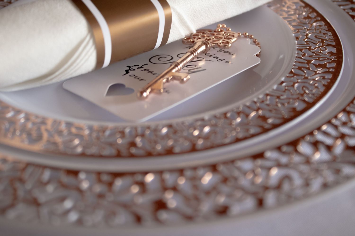 Close-up of wedding rings arranged on a decorative metallic surface with intricate patterns.