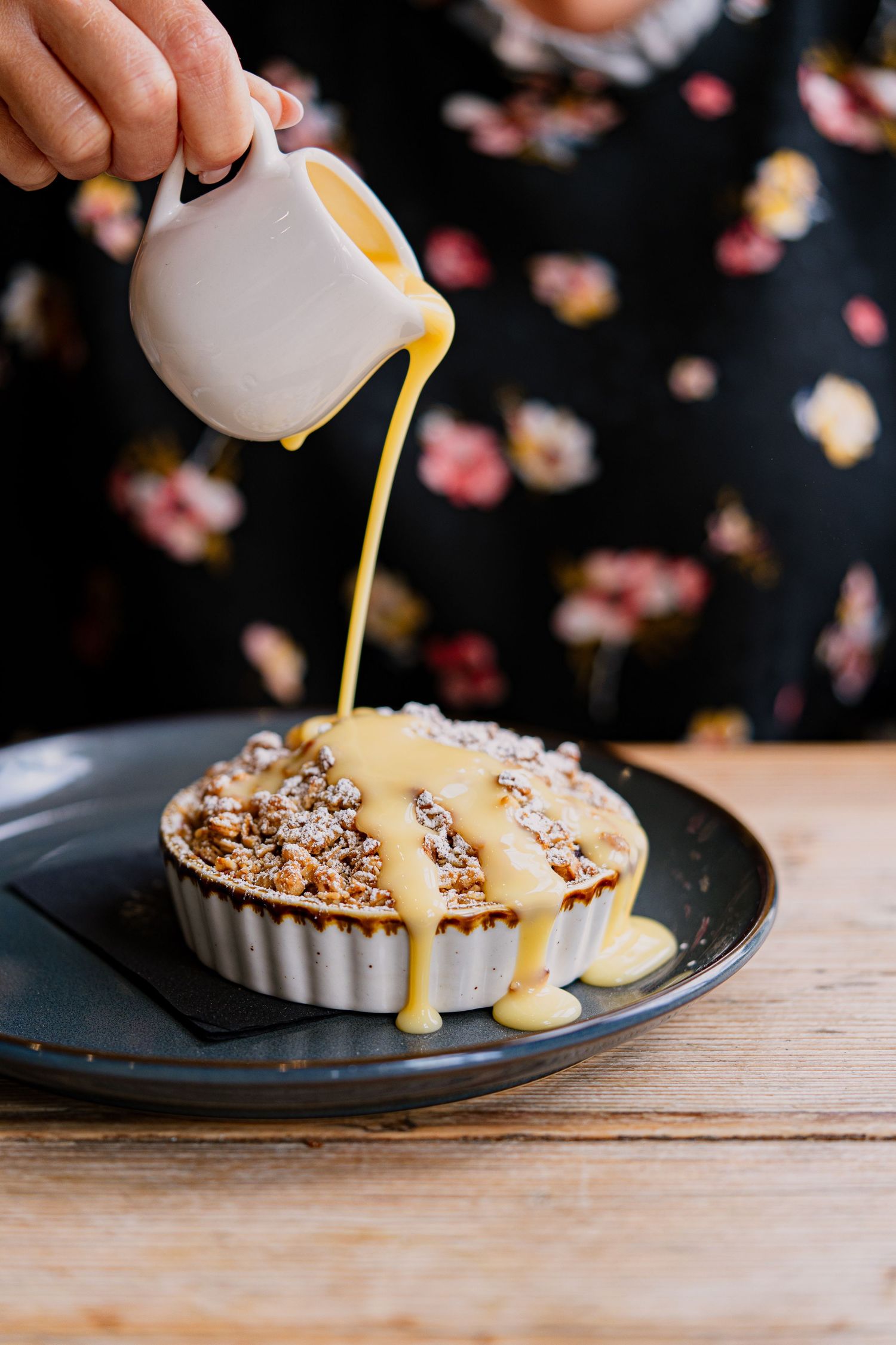 Restaurant photography, apple crumble with custard pour