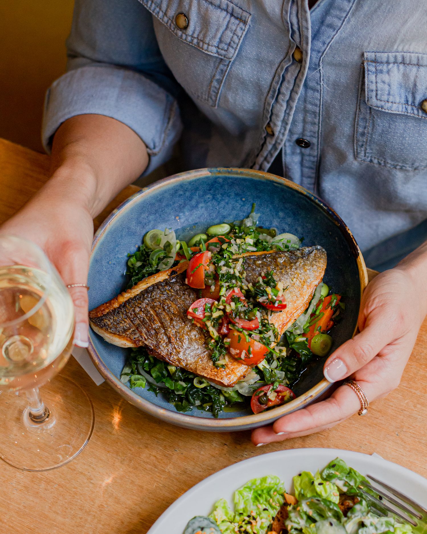 Restaurant photography, sea bass main dish with a glass of white wine