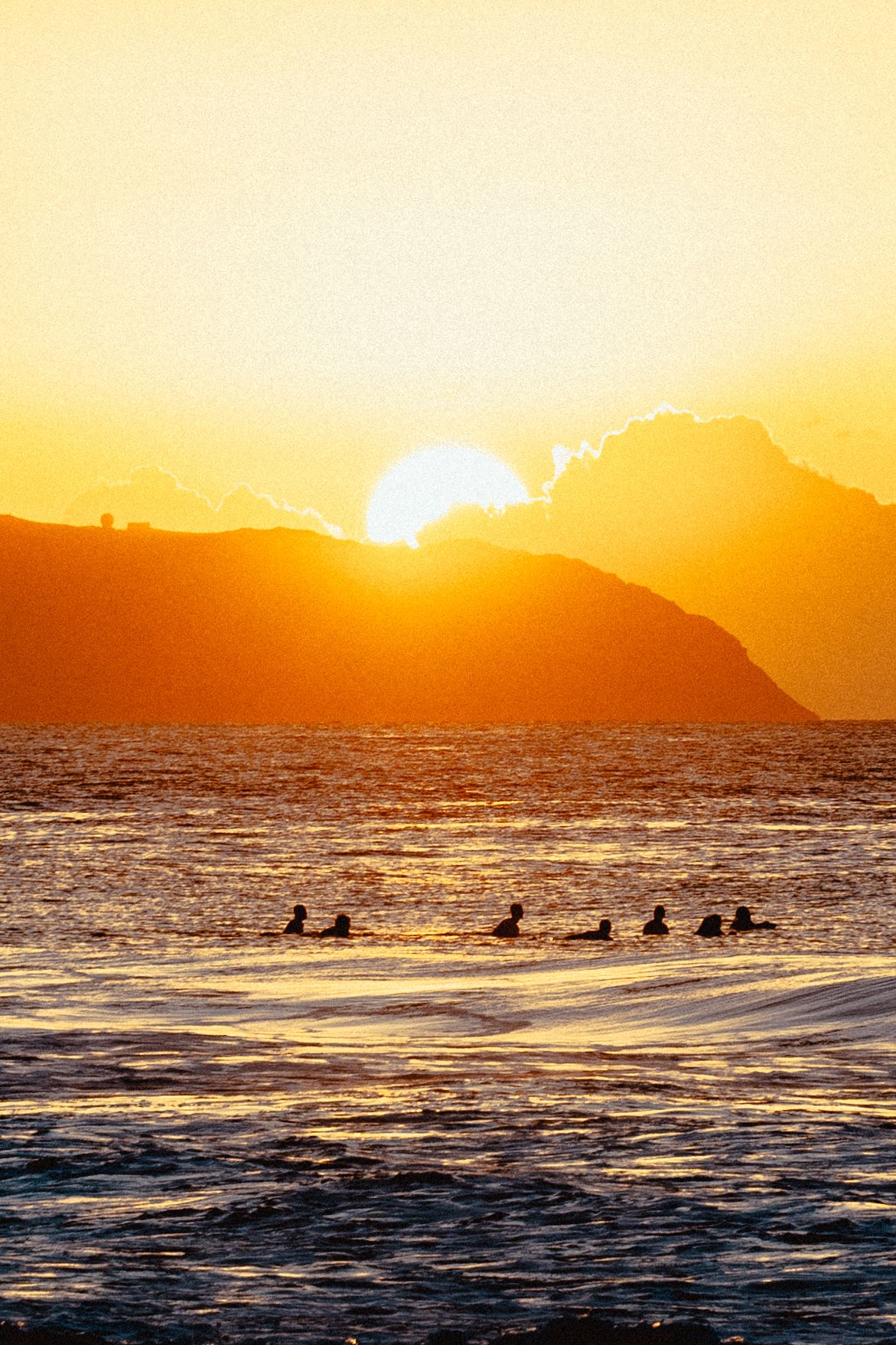 Sunset at Pipeline, North Shore, Oahu Hawaii. Surfers