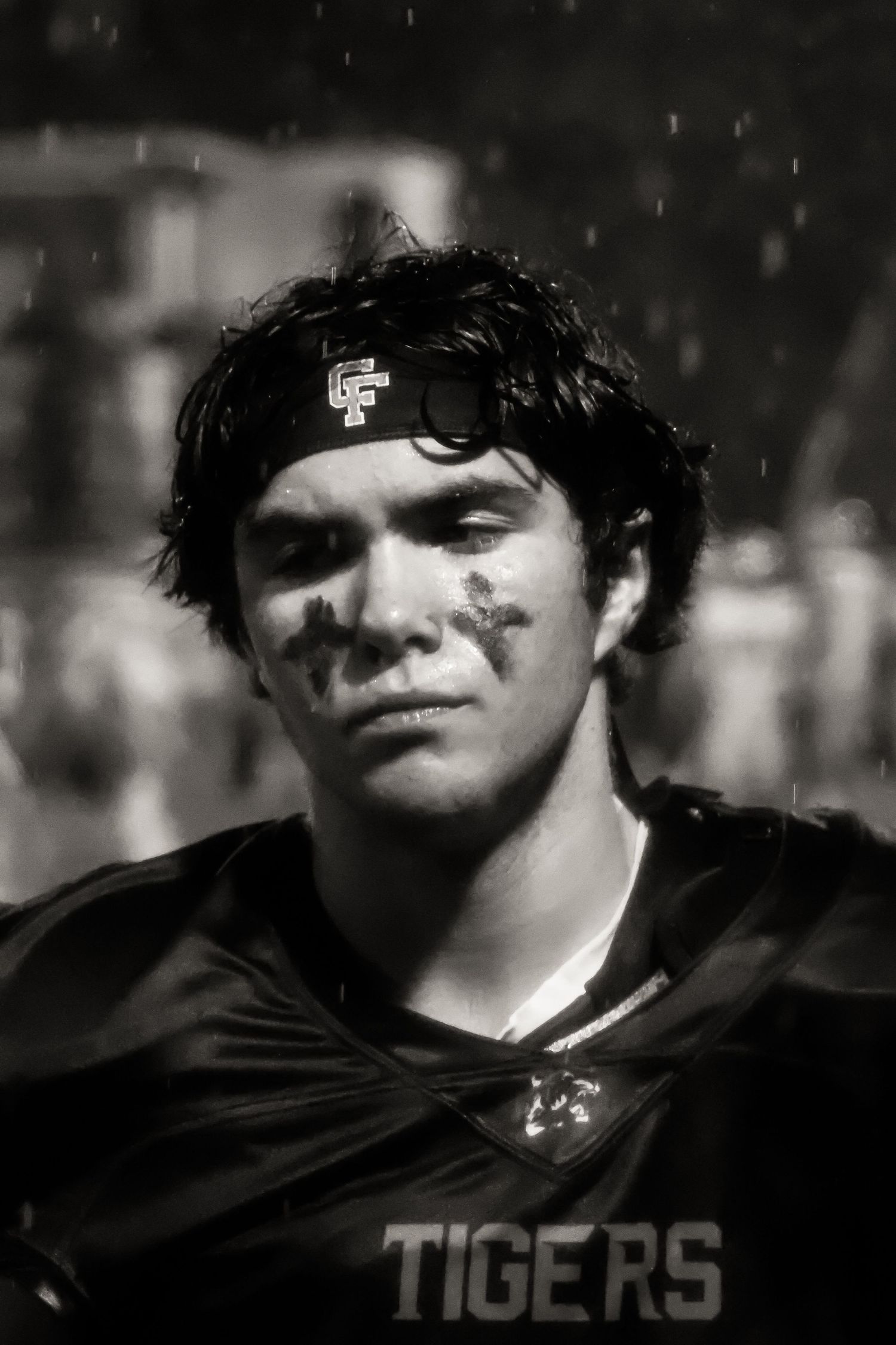 Black and white portrait of high school football player in Tigers jersey.