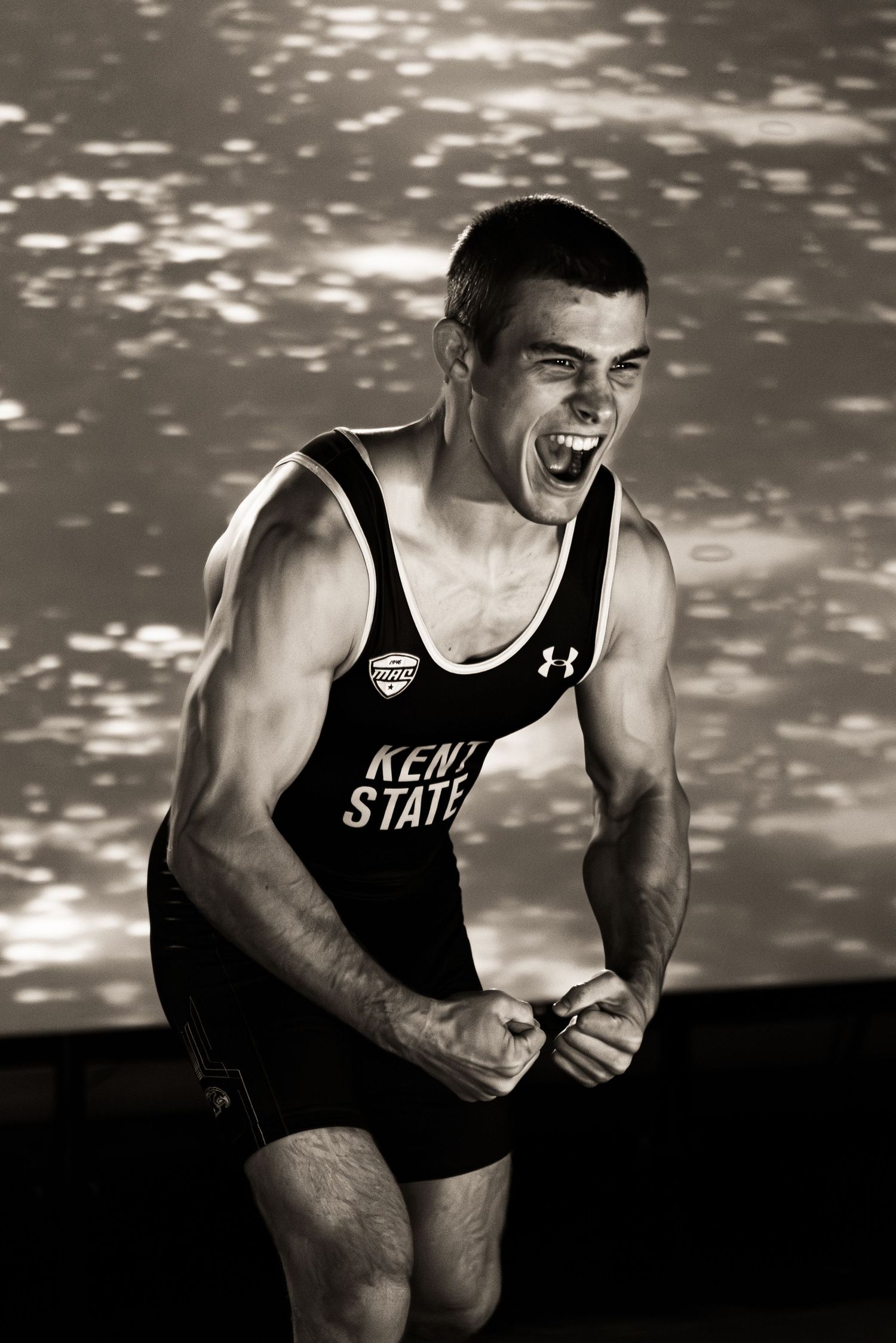 Black and white photo sequence showing an athlete in a Kent State tank top expressing intense emotion during competition.
