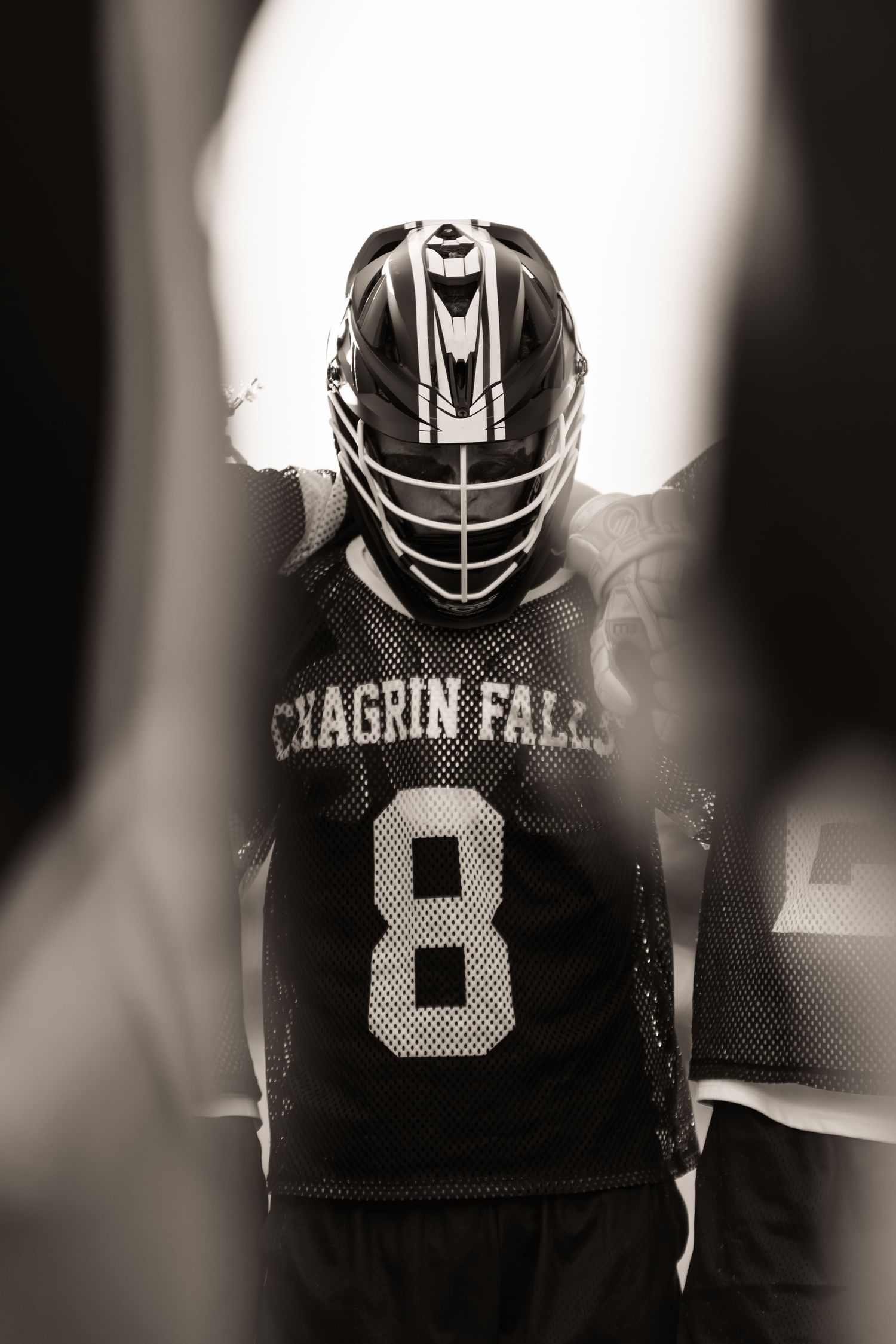 Dramatic black and white portrait of football helmets showing Chagrin Falls team branding.