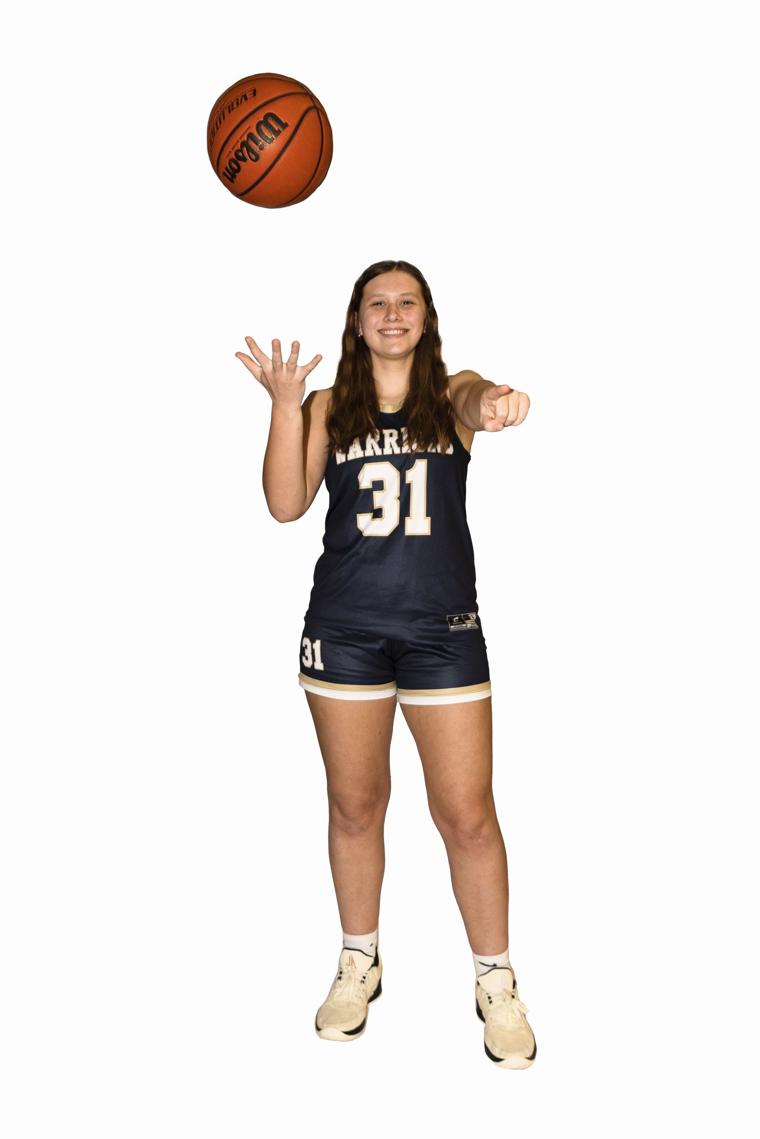 Basketball player in navy Warriors jersey number 31 tosses ball in the air on white background.