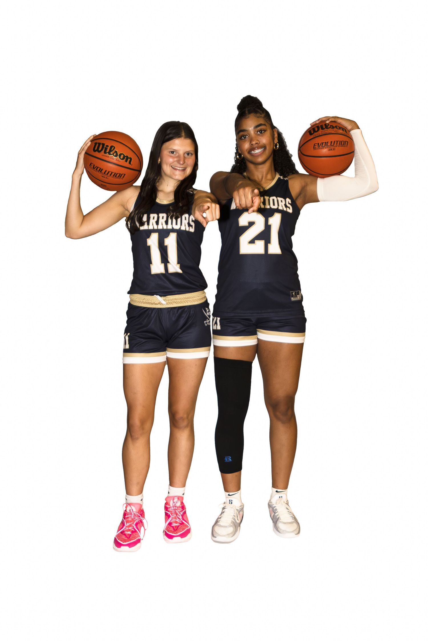 Two basketball players in navy uniforms numbered 11 and 21 pose together holding basketballs against white background.