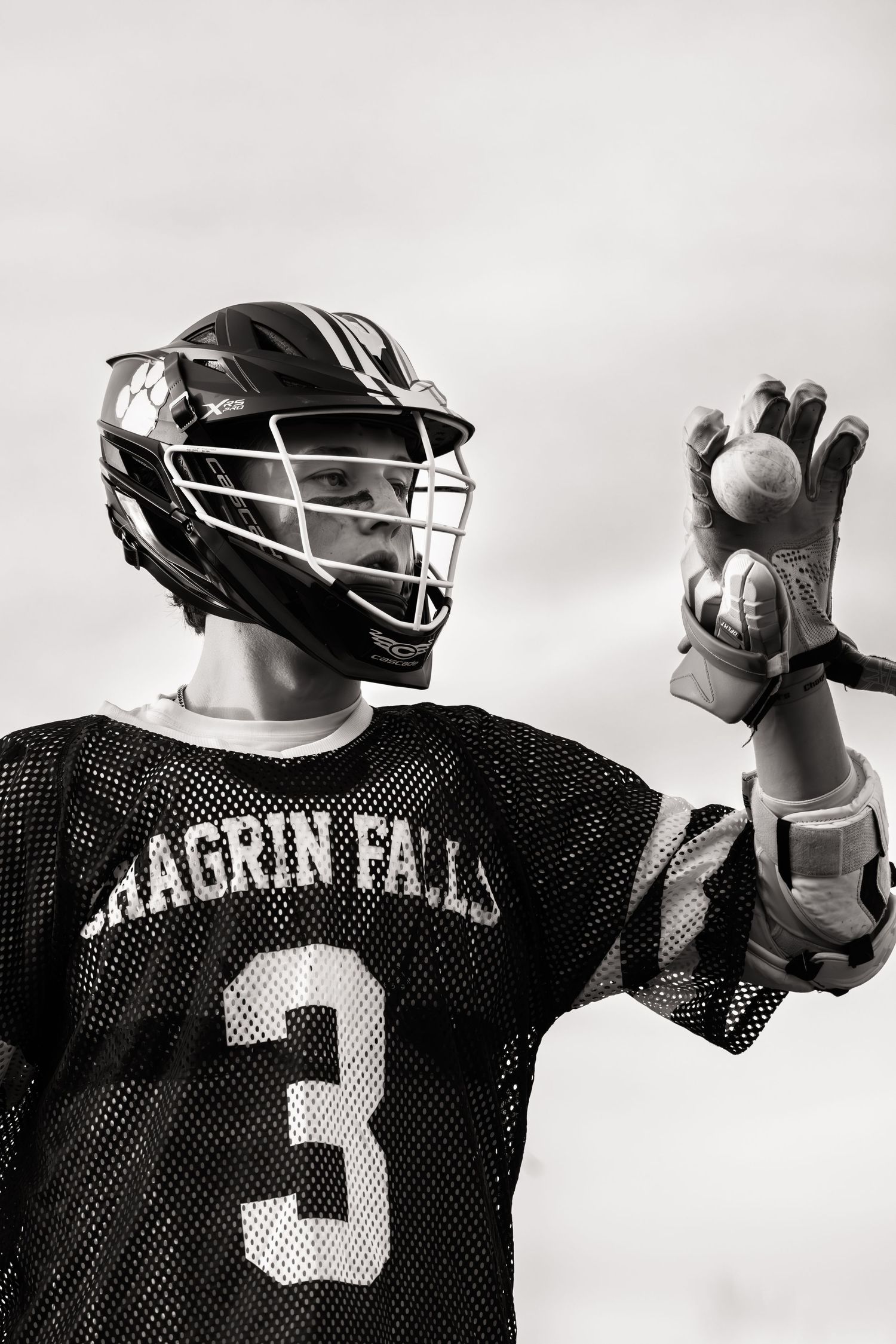 Lacrosse player in Chagrin Falls jersey number 3 holds ball in black and white portrait.