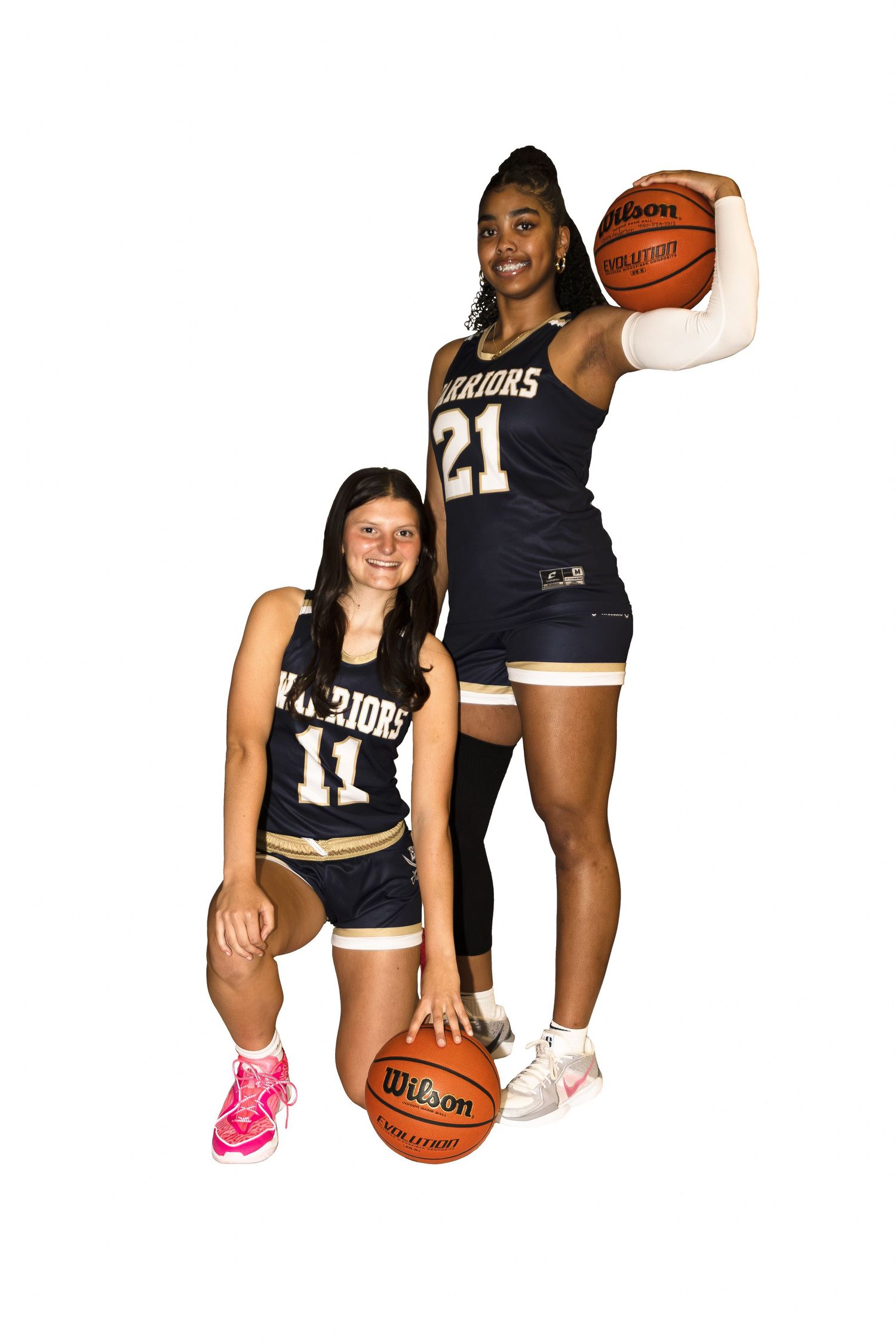 Basketball players in black and white uniforms pose together for team promotional photos.
